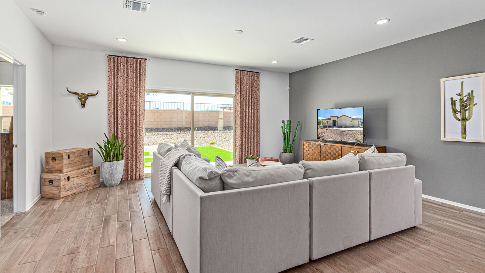 Step into The Kingston at Hanson Ridge in Vail Arizona – a perfect blend of comfort, modern living, and energy efficiency. This thoughtfully crafted single-story home spans 2,053 square feet and has four bedrooms and two bathrooms. This newly designed model offers harmony of comfort and desert elegance.  The open-concept design features a spacious great room that effortlessly connects with the kitchen and dining area, creating an inviting central hub for everyday living and entertaining. The kitchen is equipped with contemporary appliances and a pantry, offering ample storage and convenience for meal preparation and large center island. The primary bedroom, located at the rear of the home, provides a peaceful retreat with a private ensuite bathroom and a generous walk-in closet. The additional three bedrooms are positioned at the front of the house, offering versatility for use as guest rooms, a home office, or children’s bedrooms. Step outside to the covered patio, a perfect spot to enjoy the beautiful Arizona weather, whether for morning coffee or evening relaxation.  Built with energy efficiency as a priority, The Kingston includes smart home technology, which not only simplifies daily living but also helps reduce utility costs. A two-car garage provides ample parking and additional storage space, enhancing the home’s functionality. The Kingston at Hanson Ridge meets DOE Zero Energy Ready Home standards, ensuring sustainability and long-term savings.  Living at Hanson Ridge means more than just having a beautiful home. The community offers a peaceful lifestyle with incredible desert landscapes, mountain views, and easy access to I-10 for convenient commutes to Tucson and surrounding areas. Experience the charm and comfort of The Kingston at Hanson Ridge, where modern convenience meets the beauty of Arizona’s desert landscape.  *Images shown are for reference only. They depict The Kingston sales model home and may not represent the actual home.