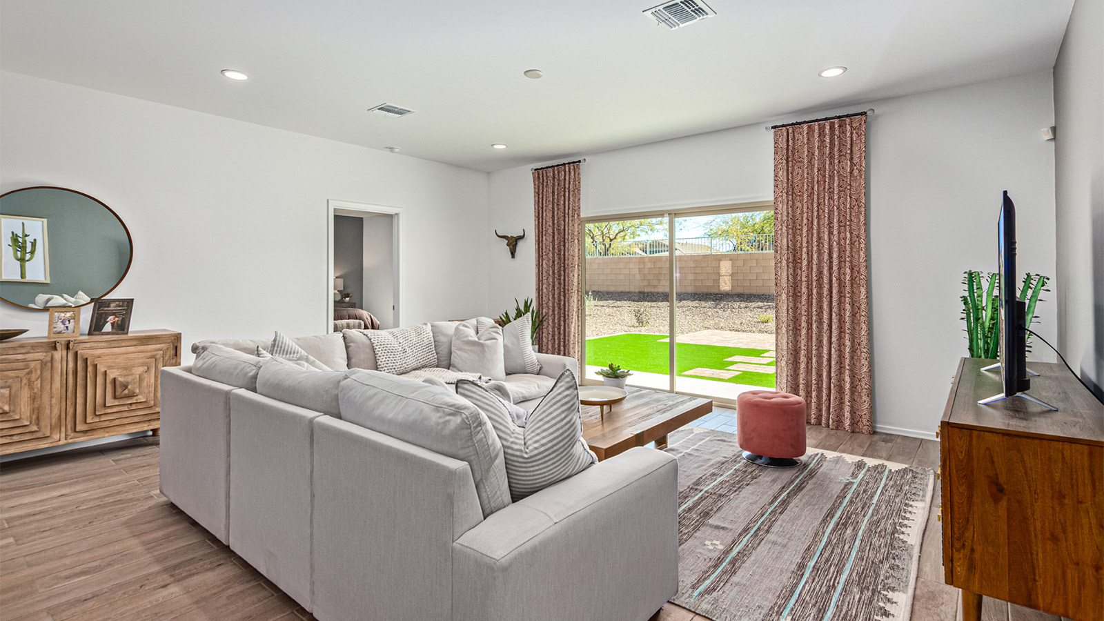 Step into The Kingston at Hanson Ridge in Vail Arizona – a perfect blend of comfort, modern living, and energy efficiency. This thoughtfully crafted single-story home spans 2,053 square feet and has four bedrooms and two bathrooms. This newly designed model offers harmony of comfort and desert elegance.  The open-concept design features a spacious great room that effortlessly connects with the kitchen and dining area, creating an inviting central hub for everyday living and entertaining. The kitchen is equipped with contemporary appliances and a pantry, offering ample storage and convenience for meal preparation and large center island. The primary bedroom, located at the rear of the home, provides a peaceful retreat with a private ensuite bathroom and a generous walk-in closet. The additional three bedrooms are positioned at the front of the house, offering versatility for use as guest rooms, a home office, or children’s bedrooms. Step outside to the covered patio, a perfect spot to enjoy the beautiful Arizona weather, whether for morning coffee or evening relaxation.  Built with energy efficiency as a priority, The Kingston includes smart home technology, which not only simplifies daily living but also helps reduce utility costs. A two-car garage provides ample parking and additional storage space, enhancing the home’s functionality. The Kingston at Hanson Ridge meets DOE Zero Energy Ready Home standards, ensuring sustainability and long-term savings.  Living at Hanson Ridge means more than just having a beautiful home. The community offers a peaceful lifestyle with incredible desert landscapes, mountain views, and easy access to I-10 for convenient commutes to Tucson and surrounding areas. Experience the charm and comfort of The Kingston at Hanson Ridge, where modern convenience meets the beauty of Arizona’s desert landscape.  *Images shown are for reference only. They depict The Kingston sales model home and may not represent the actual home.