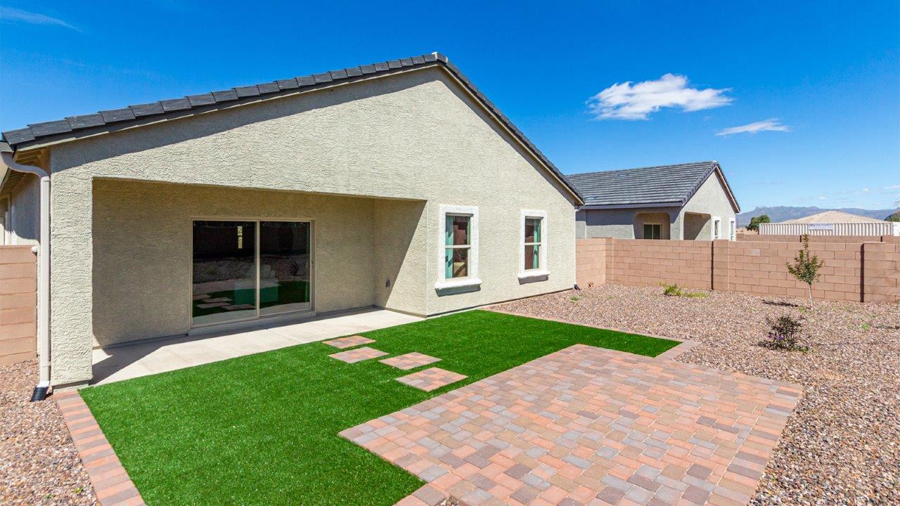 Step into The Kingston at Hanson Ridge in Vail Arizona – a perfect blend of comfort, modern living, and energy efficiency. This thoughtfully crafted single-story home spans 2,053 square feet and has four bedrooms and two bathrooms. This newly designed model offers harmony of comfort and desert elegance.  The open-concept design features a spacious great room that effortlessly connects with the kitchen and dining area, creating an inviting central hub for everyday living and entertaining. The kitchen is equipped with contemporary appliances and a pantry, offering ample storage and convenience for meal preparation and large center island. The primary bedroom, located at the rear of the home, provides a peaceful retreat with a private ensuite bathroom and a generous walk-in closet. The additional three bedrooms are positioned at the front of the house, offering versatility for use as guest rooms, a home office, or children’s bedrooms. Step outside to the covered patio, a perfect spot to enjoy the beautiful Arizona weather, whether for morning coffee or evening relaxation.  Built with energy efficiency as a priority, The Kingston includes smart home technology, which not only simplifies daily living but also helps reduce utility costs. A two-car garage provides ample parking and additional storage space, enhancing the home’s functionality. The Kingston at Hanson Ridge meets DOE Zero Energy Ready Home standards, ensuring sustainability and long-term savings.  Living at Hanson Ridge means more than just having a beautiful home. The community offers a peaceful lifestyle with incredible desert landscapes, mountain views, and easy access to I-10 for convenient commutes to Tucson and surrounding areas. Experience the charm and comfort of The Kingston at Hanson Ridge, where modern convenience meets the beauty of Arizona’s desert landscape.  *Images shown are for reference only. They depict The Kingston sales model home and may not represent the actual home.