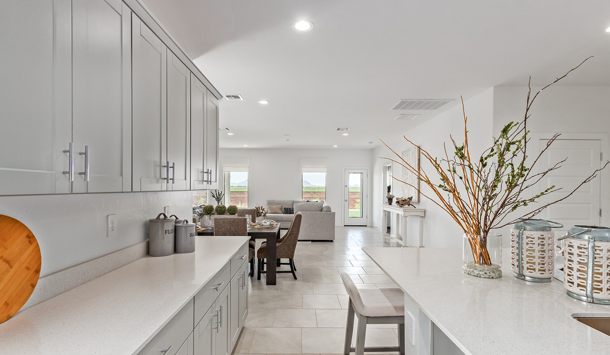 Step into The Kingston at Hanson Ridge in Vail Arizona – a perfect blend of comfort, modern living, and energy efficiency. This thoughtfully crafted single-story home spans 2,053 square feet and has four bedrooms and two bathrooms. This newly designed model offers harmony of comfort and desert elegance.  The open-concept design features a spacious great room that effortlessly connects with the kitchen and dining area, creating an inviting central hub for everyday living and entertaining. The kitchen is equipped with contemporary appliances and a pantry, offering ample storage and convenience for meal preparation and large center island. The primary bedroom, located at the rear of the home, provides a peaceful retreat with a private ensuite bathroom and a generous walk-in closet. The additional three bedrooms are positioned at the front of the house, offering versatility for use as guest rooms, a home office, or children’s bedrooms. Step outside to the covered patio, a perfect spot to enjoy the beautiful Arizona weather, whether for morning coffee or evening relaxation.  Built with energy efficiency as a priority, The Kingston includes smart home technology, which not only simplifies daily living but also helps reduce utility costs. A two-car garage provides ample parking and additional storage space, enhancing the home’s functionality. The Kingston at Hanson Ridge meets DOE Zero Energy Ready Home standards, ensuring sustainability and long-term savings.  Living at Hanson Ridge means more than just having a beautiful home. The community offers a peaceful lifestyle with incredible desert landscapes, mountain views, and easy access to I-10 for convenient commutes to Tucson and surrounding areas. Experience the charm and comfort of The Kingston at Hanson Ridge, where modern convenience meets the beauty of Arizona’s desert landscape.  *Images shown are for reference only. They depict the sales model home and may not represent the actual home.