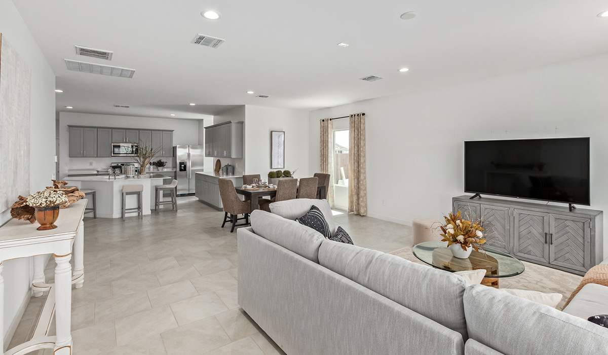 Step into The Kingston at Hanson Ridge in Vail Arizona – a perfect blend of comfort, modern living, and energy efficiency. This thoughtfully crafted single-story home spans 2,053 square feet and has four bedrooms and two bathrooms. This newly designed model offers harmony of comfort and desert elegance.  The open-concept design features a spacious great room that effortlessly connects with the kitchen and dining area, creating an inviting central hub for everyday living and entertaining. The kitchen is equipped with contemporary appliances and a pantry, offering ample storage and convenience for meal preparation and large center island. The primary bedroom, located at the rear of the home, provides a peaceful retreat with a private ensuite bathroom and a generous walk-in closet. The additional three bedrooms are positioned at the front of the house, offering versatility for use as guest rooms, a home office, or children’s bedrooms. Step outside to the covered patio, a perfect spot to enjoy the beautiful Arizona weather, whether for morning coffee or evening relaxation.  Built with energy efficiency as a priority, The Kingston includes smart home technology, which not only simplifies daily living but also helps reduce utility costs. A two-car garage provides ample parking and additional storage space, enhancing the home’s functionality. The Kingston at Hanson Ridge meets DOE Zero Energy Ready Home standards, ensuring sustainability and long-term savings.  Living at Hanson Ridge means more than just having a beautiful home. The community offers a peaceful lifestyle with incredible desert landscapes, mountain views, and easy access to I-10 for convenient commutes to Tucson and surrounding areas. Experience the charm and comfort of The Kingston at Hanson Ridge, where modern convenience meets the beauty of Arizona’s desert landscape.  *Images shown are for reference only. They depict the sales model home and may not represent the actual home.