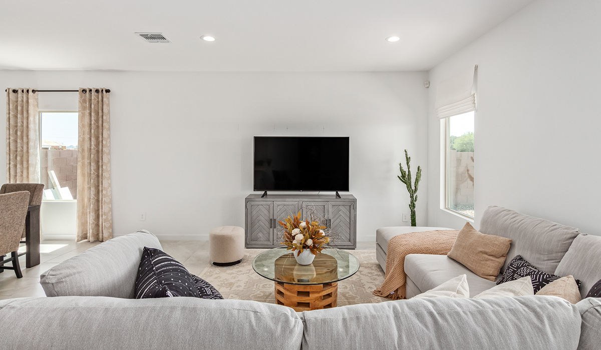 Step into The Kingston at Hanson Ridge in Vail Arizona – a perfect blend of comfort, modern living, and energy efficiency. This thoughtfully crafted single-story home spans 2,053 square feet and has four bedrooms and two bathrooms. This newly designed model offers harmony of comfort and desert elegance.  The open-concept design features a spacious great room that effortlessly connects with the kitchen and dining area, creating an inviting central hub for everyday living and entertaining. The kitchen is equipped with contemporary appliances and a pantry, offering ample storage and convenience for meal preparation and large center island. The primary bedroom, located at the rear of the home, provides a peaceful retreat with a private ensuite bathroom and a generous walk-in closet. The additional three bedrooms are positioned at the front of the house, offering versatility for use as guest rooms, a home office, or children’s bedrooms. Step outside to the covered patio, a perfect spot to enjoy the beautiful Arizona weather, whether for morning coffee or evening relaxation.  Built with energy efficiency as a priority, The Kingston includes smart home technology, which not only simplifies daily living but also helps reduce utility costs. A two-car garage provides ample parking and additional storage space, enhancing the home’s functionality. The Kingston at Hanson Ridge meets DOE Zero Energy Ready Home standards, ensuring sustainability and long-term savings.  Living at Hanson Ridge means more than just having a beautiful home. The community offers a peaceful lifestyle with incredible desert landscapes, mountain views, and easy access to I-10 for convenient commutes to Tucson and surrounding areas. Experience the charm and comfort of The Kingston at Hanson Ridge, where modern convenience meets the beauty of Arizona’s desert landscape.  *Images shown are for reference only. They depict the sales model home and may not represent the actual home.