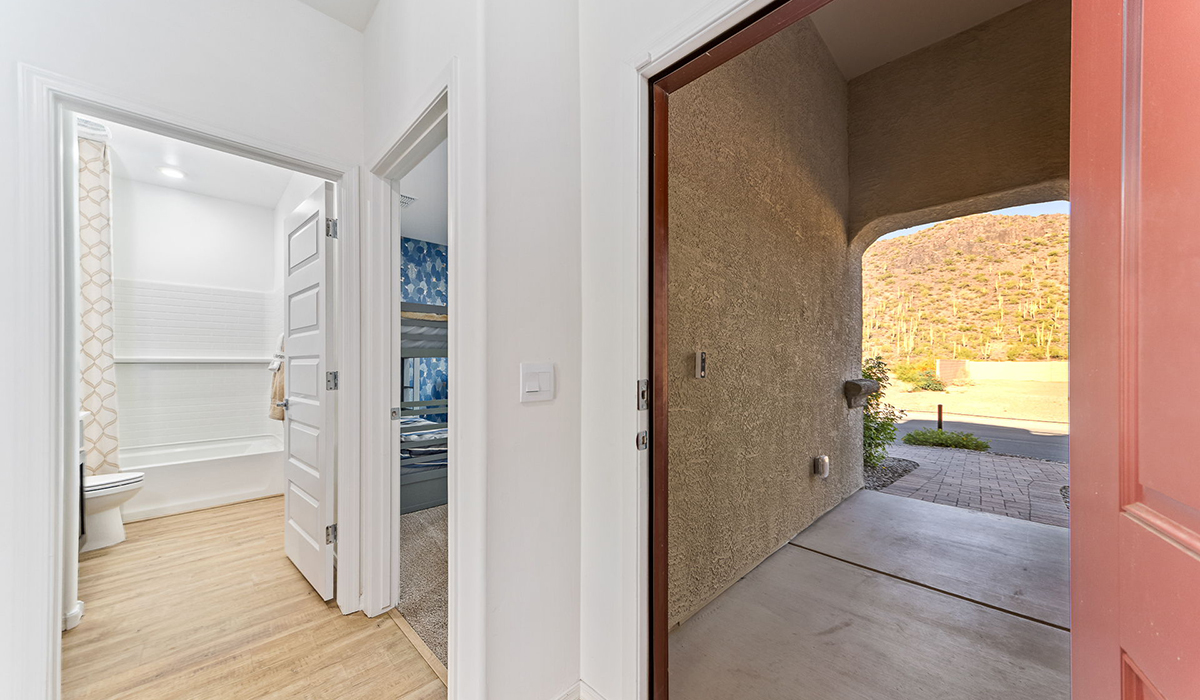 Step into The Kingston at Hanson Ridge in Vail Arizona – a perfect blend of comfort, modern living, and energy efficiency. This thoughtfully crafted single-story home spans 2,053 square feet and has four bedrooms and two bathrooms. This newly designed model offers harmony of comfort and desert elegance.  The open-concept design features a spacious great room that effortlessly connects with the kitchen and dining area, creating an inviting central hub for everyday living and entertaining. The kitchen is equipped with contemporary appliances and a pantry, offering ample storage and convenience for meal preparation and large center island. The primary bedroom, located at the rear of the home, provides a peaceful retreat with a private ensuite bathroom and a generous walk-in closet. The additional three bedrooms are positioned at the front of the house, offering versatility for use as guest rooms, a home office, or children’s bedrooms. Step outside to the covered patio, a perfect spot to enjoy the beautiful Arizona weather, whether for morning coffee or evening relaxation.  Built with energy efficiency as a priority, The Kingston includes smart home technology, which not only simplifies daily living but also helps reduce utility costs. A two-car garage provides ample parking and additional storage space, enhancing the home’s functionality. The Kingston at Hanson Ridge meets DOE Zero Energy Ready Home standards, ensuring sustainability and long-term savings.  Living at Hanson Ridge means more than just having a beautiful home. The community offers a peaceful lifestyle with incredible desert landscapes, mountain views, and easy access to I-10 for convenient commutes to Tucson and surrounding areas. Experience the charm and comfort of The Kingston at Hanson Ridge, where modern convenience meets the beauty of Arizona’s desert landscape.  *Images shown are for reference only. They depict the Kingston model home and may not represent the actual home.