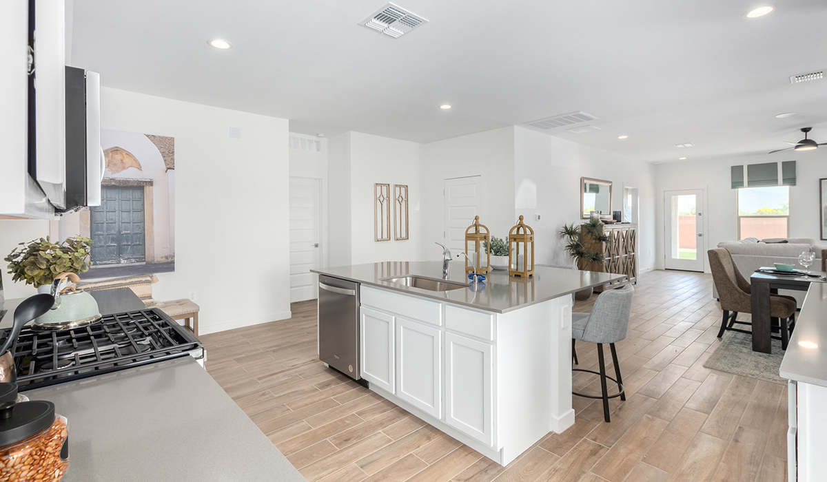 Step into The Kingston at Hanson Ridge in Vail Arizona – a perfect blend of comfort, modern living, and energy efficiency. This thoughtfully crafted single-story home spans 2,053 square feet and has four bedrooms and two bathrooms. This newly designed model offers harmony of comfort and desert elegance.  The open-concept design features a spacious great room that effortlessly connects with the kitchen and dining area, creating an inviting central hub for everyday living and entertaining. The kitchen is equipped with contemporary appliances and a pantry, offering ample storage and convenience for meal preparation and large center island. The primary bedroom, located at the rear of the home, provides a peaceful retreat with a private ensuite bathroom and a generous walk-in closet. The additional three bedrooms are positioned at the front of the house, offering versatility for use as guest rooms, a home office, or children’s bedrooms. Step outside to the covered patio, a perfect spot to enjoy the beautiful Arizona weather, whether for morning coffee or evening relaxation.  Built with energy efficiency as a priority, The Kingston includes smart home technology, which not only simplifies daily living but also helps reduce utility costs. A two-car garage provides ample parking and additional storage space, enhancing the home’s functionality. The Kingston at Hanson Ridge meets DOE Zero Energy Ready Home standards, ensuring sustainability and long-term savings.  Living at Hanson Ridge means more than just having a beautiful home. The community offers a peaceful lifestyle with incredible desert landscapes, mountain views, and easy access to I-10 for convenient commutes to Tucson and surrounding areas. Experience the charm and comfort of The Kingston at Hanson Ridge, where modern convenience meets the beauty of Arizona’s desert landscape.