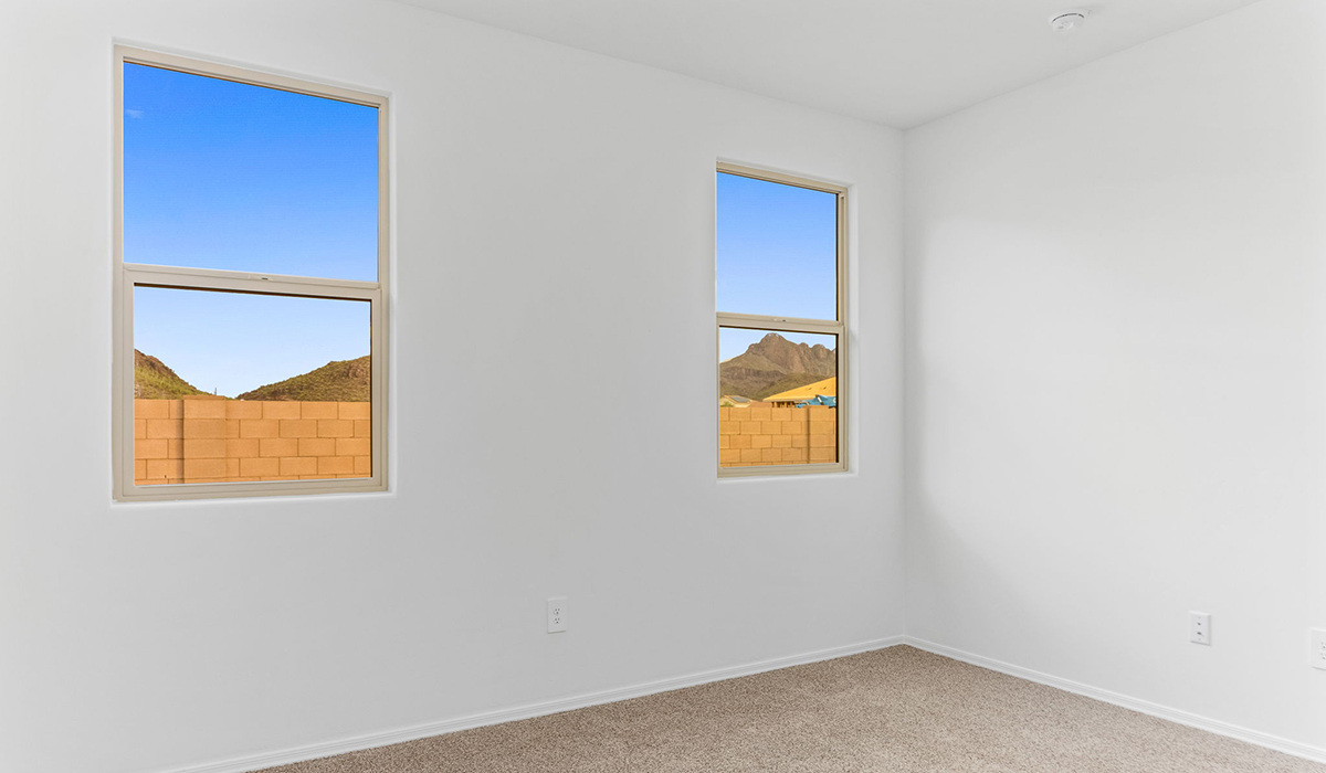 Discover the Dalea at Hanson Ridge in Vail, Arizona - a beautifully designed single-story home that perfectly balances comfort and elegance. This thoughtfully crafted floor plan offers two spacious layout options: a 2,058 sq. ft. home featuring four bedrooms and a 3-car tandem garage, or a 2,224 sq. ft. layout with five bedrooms and a two-car garage. Whether you're looking for extra space or a more open layout, the Dalea is designed to suit your lifestyle with style and functionality in every detail.  As you enter through the inviting front porch, you're welcomed into a bright and airy living space that flows seamlessly into the great room, dining area, and kitchen. This open-concept design is perfect for both family gatherings and entertaining. The kitchen features Quartz countertops, Shaker Style Cabinetry, modern appliances, and a convenient pantry, making meal preparation a breeze.  The primary suite, located at the rear of the home, providing a private retreat with a spacious a large walk-in closet, and en-suite bathroom featuring dual vanities and a walk-in shower. This suite offers a peaceful escape, ideal for relaxation. This thoughtfully designed four to five-bedroom home offers privacy and comfort with three bathrooms. The Dalea plan also includes a utility room and two-car garage with the option of three-car garage.   Living at Hanson Ridge means more than just having a beautiful home. The community offers a peaceful lifestyle with incredible desert landscapes, mountain views, and easy access to I-10 for convenient commutes to Tucson and surrounding areas. Designed with energy efficiency in mind, The Dalea at Hanson Ridge meets Zero Energy Ready Home standards, ensuring sustainability and long-term savings.  Experience the charm and comfort of The Dalea at Hanson Ridge, where modern convenience meets the beauty of Arizona’s desert landscape.