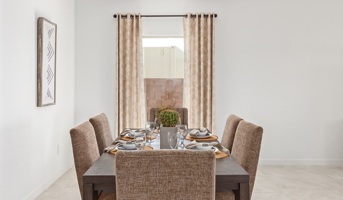 Step into The Kingston at Barnett Village, Marana, Arizona – a perfect blend of comfort, modern living, and energy efficiency. This thoughtfully crafted one-story home spans 2,068 square feet and offers four bedrooms and two bathrooms, ideal for families of all sizes.  The open-concept design features a spacious great room that effortlessly connects with the kitchen and dining area, creating an inviting central hub for everyday living and entertaining. The kitchen is equipped with contemporary appliances and a pantry, offering ample storage and convenience for meal preparation.  The primary bedroom, located at the rear of the home, provides a peaceful retreat with a private ensuite bathroom and a generous walk-in closet. The additional three bedrooms are positioned at the front of the house, offering versatility for use as guest rooms, a home office, or children’s bedrooms. Step outside to the covered patio, a perfect spot to enjoy the beautiful Arizona weather, whether for morning coffee or evening relaxation.  The Kingston also boasts a covered patio, perfect for enjoying Arizona’s beautiful desert evenings. Whether it’s morning coffee or evening relaxation, this outdoor space extends your living area into the serene landscape of Barnett Village.  Built with energy efficiency as a priority, the Kingston includes smart home technology, which not only simplifies daily living but also helps reduce utility costs. A two-car garage provides ample parking and additional storage space, enhancing the home’s functionality.