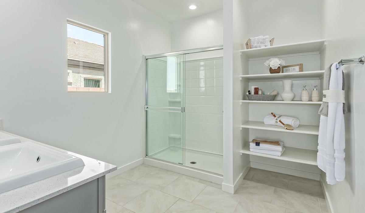 Step into The Kingston at Barnett Village, Marana, Arizona – a perfect blend of comfort, modern living, and energy efficiency. This thoughtfully crafted one-story home spans 2,068 square feet and offers four bedrooms and two bathrooms, ideal for families of all sizes.  The open-concept design features a spacious great room that effortlessly connects with the kitchen and dining area, creating an inviting central hub for everyday living and entertaining. The kitchen is equipped with contemporary appliances and a pantry, offering ample storage and convenience for meal preparation.  The primary bedroom, located at the rear of the home, provides a peaceful retreat with a private ensuite bathroom and a generous walk-in closet. The additional three bedrooms are positioned at the front of the house, offering versatility for use as guest rooms, a home office, or children’s bedrooms. Step outside to the covered patio, a perfect spot to enjoy the beautiful Arizona weather, whether for morning coffee or evening relaxation.  The Kingston also boasts a covered patio, perfect for enjoying Arizona’s beautiful desert evenings. Whether it’s morning coffee or evening relaxation, this outdoor space extends your living area into the serene landscape of Barnett Village.  Built with energy efficiency as a priority, the Kingston includes smart home technology, which not only simplifies daily living but also helps reduce utility costs. A two-car garage provides ample parking and additional storage space, enhancing the home’s functionality.