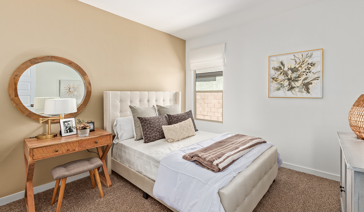 Step into The Kingston at Barnett Village, Marana, Arizona – a perfect blend of comfort, modern living, and energy efficiency. This thoughtfully crafted one-story home spans 2,068 square feet and offers four bedrooms and two bathrooms, ideal for families of all sizes.  The open-concept design features a spacious great room that effortlessly connects with the kitchen and dining area, creating an inviting central hub for everyday living and entertaining. The kitchen is equipped with contemporary appliances and a pantry, offering ample storage and convenience for meal preparation.  The primary bedroom, located at the rear of the home, provides a peaceful retreat with a private ensuite bathroom and a generous walk-in closet. The additional three bedrooms are positioned at the front of the house, offering versatility for use as guest rooms, a home office, or children’s bedrooms. Step outside to the covered patio, a perfect spot to enjoy the beautiful Arizona weather, whether for morning coffee or evening relaxation.  The Kingston also boasts a covered patio, perfect for enjoying Arizona’s beautiful desert evenings. Whether it’s morning coffee or evening relaxation, this outdoor space extends your living area into the serene landscape of Barnett Village.  Built with energy efficiency as a priority, the Kingston includes smart home technology, which not only simplifies daily living but also helps reduce utility costs. A two-car garage provides ample parking and additional storage space, enhancing the home’s functionality.