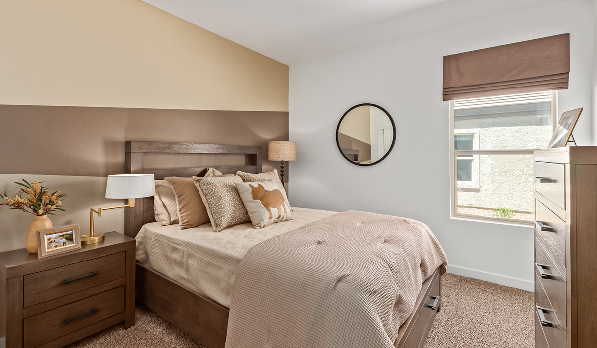 Step into The Kingston at Barnett Village, Marana, Arizona – a perfect blend of comfort, modern living, and energy efficiency. This thoughtfully crafted one-story home spans 2,068 square feet and offers four bedrooms and two bathrooms, ideal for families of all sizes.  The open-concept design features a spacious great room that effortlessly connects with the kitchen and dining area, creating an inviting central hub for everyday living and entertaining. The kitchen is equipped with contemporary appliances and a pantry, offering ample storage and convenience for meal preparation.  The primary bedroom, located at the rear of the home, provides a peaceful retreat with a private ensuite bathroom and a generous walk-in closet. The additional three bedrooms are positioned at the front of the house, offering versatility for use as guest rooms, a home office, or children’s bedrooms. Step outside to the covered patio, a perfect spot to enjoy the beautiful Arizona weather, whether for morning coffee or evening relaxation.  The Kingston also boasts a covered patio, perfect for enjoying Arizona’s beautiful desert evenings. Whether it’s morning coffee or evening relaxation, this outdoor space extends your living area into the serene landscape of Barnett Village.  Built with energy efficiency as a priority, the Kingston includes smart home technology, which not only simplifies daily living but also helps reduce utility costs. A two-car garage provides ample parking and additional storage space, enhancing the home’s functionality.