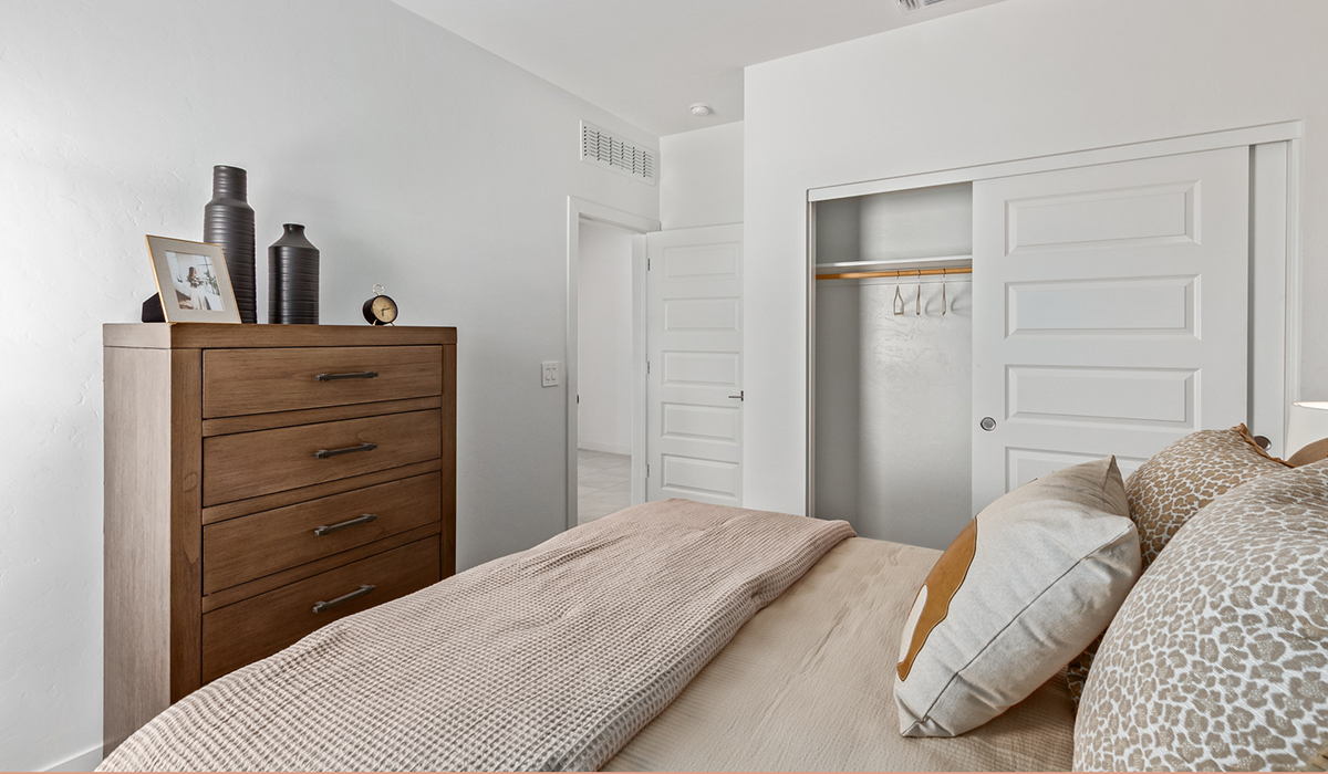 Step into The Kingston at Barnett Village, Marana, Arizona – a perfect blend of comfort, modern living, and energy efficiency. This thoughtfully crafted one-story home spans 2,068 square feet and offers four bedrooms and two bathrooms, ideal for families of all sizes.  The open-concept design features a spacious great room that effortlessly connects with the kitchen and dining area, creating an inviting central hub for everyday living and entertaining. The kitchen is equipped with contemporary appliances and a pantry, offering ample storage and convenience for meal preparation.  The primary bedroom, located at the rear of the home, provides a peaceful retreat with a private ensuite bathroom and a generous walk-in closet. The additional three bedrooms are positioned at the front of the house, offering versatility for use as guest rooms, a home office, or children’s bedrooms. Step outside to the covered patio, a perfect spot to enjoy the beautiful Arizona weather, whether for morning coffee or evening relaxation.  The Kingston also boasts a covered patio, perfect for enjoying Arizona’s beautiful desert evenings. Whether it’s morning coffee or evening relaxation, this outdoor space extends your living area into the serene landscape of Barnett Village.  Built with energy efficiency as a priority, the Kingston includes smart home technology, which not only simplifies daily living but also helps reduce utility costs. A two-car garage provides ample parking and additional storage space, enhancing the home’s functionality.