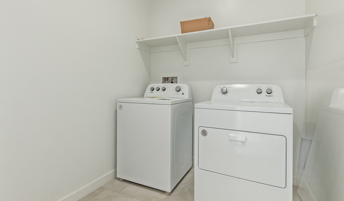 Step into The Kingston at Barnett Village, Marana, Arizona – a perfect blend of comfort, modern living, and energy efficiency. This thoughtfully crafted one-story home spans 2,068 square feet and offers four bedrooms and two bathrooms, ideal for families of all sizes.  The open-concept design features a spacious great room that effortlessly connects with the kitchen and dining area, creating an inviting central hub for everyday living and entertaining. The kitchen is equipped with contemporary appliances and a pantry, offering ample storage and convenience for meal preparation.  The primary bedroom, located at the rear of the home, provides a peaceful retreat with a private ensuite bathroom and a generous walk-in closet. The additional three bedrooms are positioned at the front of the house, offering versatility for use as guest rooms, a home office, or children’s bedrooms. Step outside to the covered patio, a perfect spot to enjoy the beautiful Arizona weather, whether for morning coffee or evening relaxation.  The Kingston also boasts a covered patio, perfect for enjoying Arizona’s beautiful desert evenings. Whether it’s morning coffee or evening relaxation, this outdoor space extends your living area into the serene landscape of Barnett Village.  Built with energy efficiency as a priority, the Kingston includes smart home technology, which not only simplifies daily living but also helps reduce utility costs. A two-car garage provides ample parking and additional storage space, enhancing the home’s functionality.