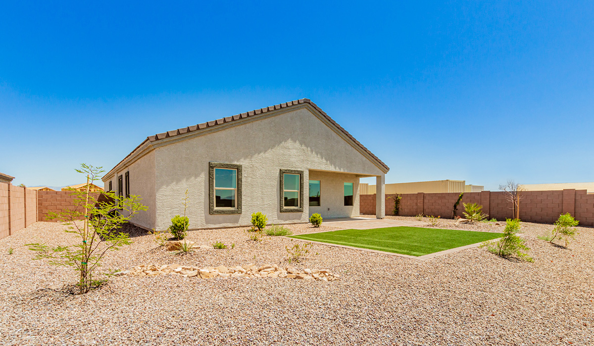 Step into The Kingston at Barnett Village, Marana, Arizona – a perfect blend of comfort, modern living, and energy efficiency. This thoughtfully crafted one-story home spans 2,068 square feet and offers four bedrooms and two bathrooms, ideal for families of all sizes.  The open-concept design features a spacious great room that effortlessly connects with the kitchen and dining area, creating an inviting central hub for everyday living and entertaining. The kitchen is equipped with contemporary appliances and a pantry, offering ample storage and convenience for meal preparation.  The primary bedroom, located at the rear of the home, provides a peaceful retreat with a private ensuite bathroom and a generous walk-in closet. The additional three bedrooms are positioned at the front of the house, offering versatility for use as guest rooms, a home office, or children’s bedrooms. Step outside to the covered patio, a perfect spot to enjoy the beautiful Arizona weather, whether for morning coffee or evening relaxation.  The Kingston also boasts a covered patio, perfect for enjoying Arizona’s beautiful desert evenings. Whether it’s morning coffee or evening relaxation, this outdoor space extends your living area into the serene landscape of Barnett Village.  Built with energy efficiency as a priority, the Kingston includes smart home technology, which not only simplifies daily living but also helps reduce utility costs. A two-car garage provides ample parking and additional storage space, enhancing the home’s functionality.