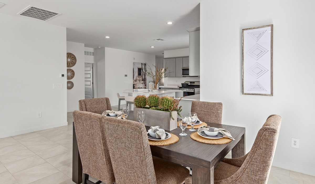 Step into The Kingston at Barnett Village, Marana, Arizona – a perfect blend of comfort, modern living, and energy efficiency. This thoughtfully crafted one-story home spans 2,068 square feet and offers four bedrooms and two bathrooms, ideal for families of all sizes.  The open-concept design features a spacious great room that effortlessly connects with the kitchen and dining area, creating an inviting central hub for everyday living and entertaining. The kitchen is equipped with contemporary appliances and a pantry, offering ample storage and convenience for meal preparation.  The primary bedroom, located at the rear of the home, provides a peaceful retreat with a private ensuite bathroom and a generous walk-in closet. The additional three bedrooms are positioned at the front of the house, offering versatility for use as guest rooms, a home office, or children’s bedrooms. Step outside to the covered patio, a perfect spot to enjoy the beautiful Arizona weather, whether for morning coffee or evening relaxation.  The Kingston also boasts a covered patio, perfect for enjoying Arizona’s beautiful desert evenings. Whether it’s morning coffee or evening relaxation, this outdoor space extends your living area into the serene landscape of Barnett Village.  Built with energy efficiency as a priority, the Kingston includes smart home technology, which not only simplifies daily living but also helps reduce utility costs. A two-car garage provides ample parking and additional storage space, enhancing the home’s functionality.