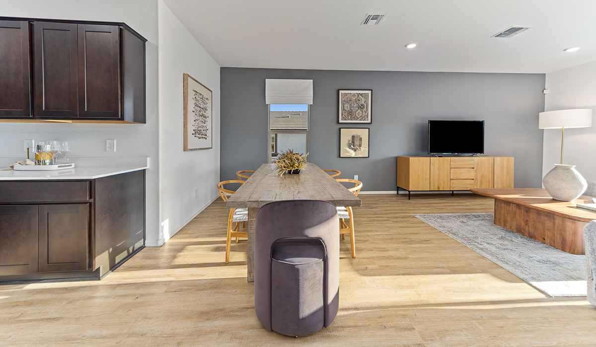 Step into The Kingston at Barnett Village, Marana, Arizona – a perfect blend of comfort, modern living, and energy efficiency. This thoughtfully crafted one-story home spans 2,068 square feet and offers four bedrooms and two bathrooms, ideal for families of all sizes.  The open-concept design features a spacious great room that effortlessly connects with the kitchen and dining area, creating an inviting central hub for everyday living and entertaining. The kitchen is equipped with contemporary appliances and a pantry, offering ample storage and convenience for meal preparation.  The primary bedroom, located at the rear of the home, provides a peaceful retreat with a private ensuite bathroom and a generous walk-in closet. The additional three bedrooms are positioned at the front of the house, offering versatility for use as guest rooms, a home office, or children’s bedrooms. Step outside to the covered patio, a perfect spot to enjoy the beautiful Arizona weather, whether for morning coffee or evening relaxation.  The Kingston also boasts a covered patio, perfect for enjoying Arizona’s beautiful desert evenings. Whether it’s morning coffee or evening relaxation, this outdoor space extends your living area into the serene landscape of Barnett Village.  Built with energy efficiency as a priority, the Kingston includes smart home technology, which not only simplifies daily living but also helps reduce utility costs. A two-car garage provides ample parking and additional storage space, enhancing the home’s functionality.  Images shown are for reference only. They depict the sales model home and may not represent the actual home.