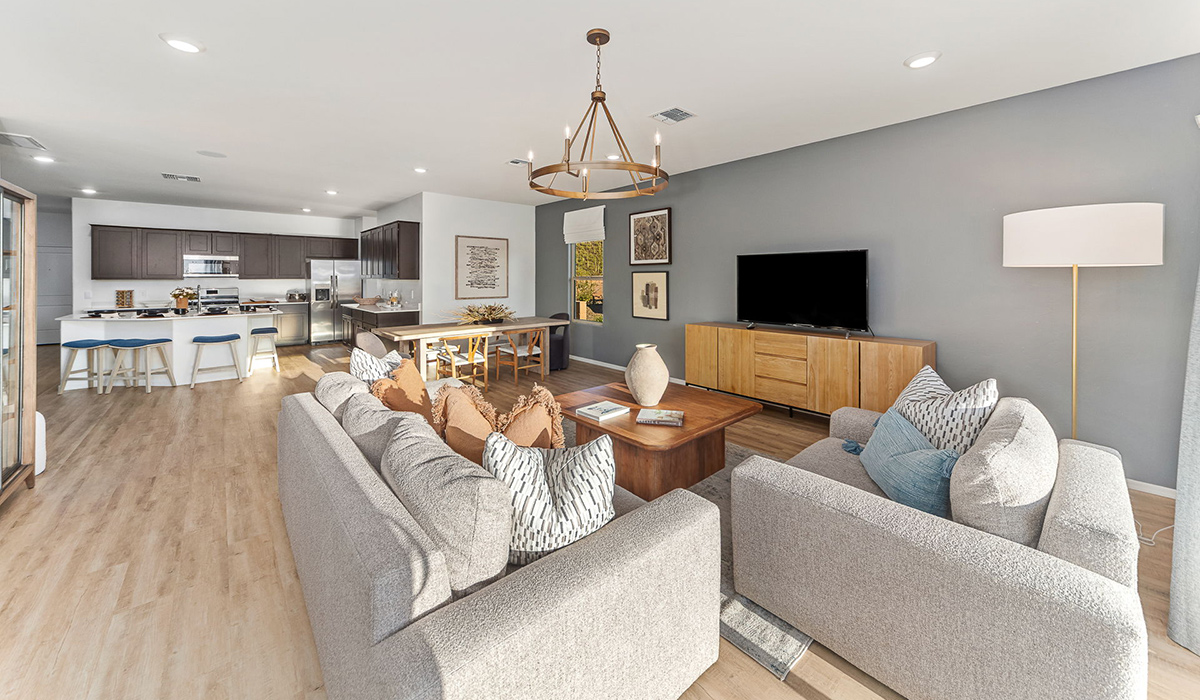 Step into The Kingston at Barnett Village, Marana, Arizona – a perfect blend of comfort, modern living, and energy efficiency. This thoughtfully crafted one-story home spans 2,068 square feet and offers four bedrooms and two bathrooms, ideal for families of all sizes.  The open-concept design features a spacious great room that effortlessly connects with the kitchen and dining area, creating an inviting central hub for everyday living and entertaining. The kitchen is equipped with contemporary appliances and a pantry, offering ample storage and convenience for meal preparation.  The primary bedroom, located at the rear of the home, provides a peaceful retreat with a private ensuite bathroom and a generous walk-in closet. The additional three bedrooms are positioned at the front of the house, offering versatility for use as guest rooms, a home office, or children’s bedrooms. Step outside to the covered patio, a perfect spot to enjoy the beautiful Arizona weather, whether for morning coffee or evening relaxation.  The Kingston also boasts a covered patio, perfect for enjoying Arizona’s beautiful desert evenings. Whether it’s morning coffee or evening relaxation, this outdoor space extends your living area into the serene landscape of Barnett Village.  Built with energy efficiency as a priority, the Kingston includes smart home technology, which not only simplifies daily living but also helps reduce utility costs. A two-car garage provides ample parking and additional storage space, enhancing the home’s functionality.  Images shown are for reference only. They depict the sales model home and may not represent the actual home.