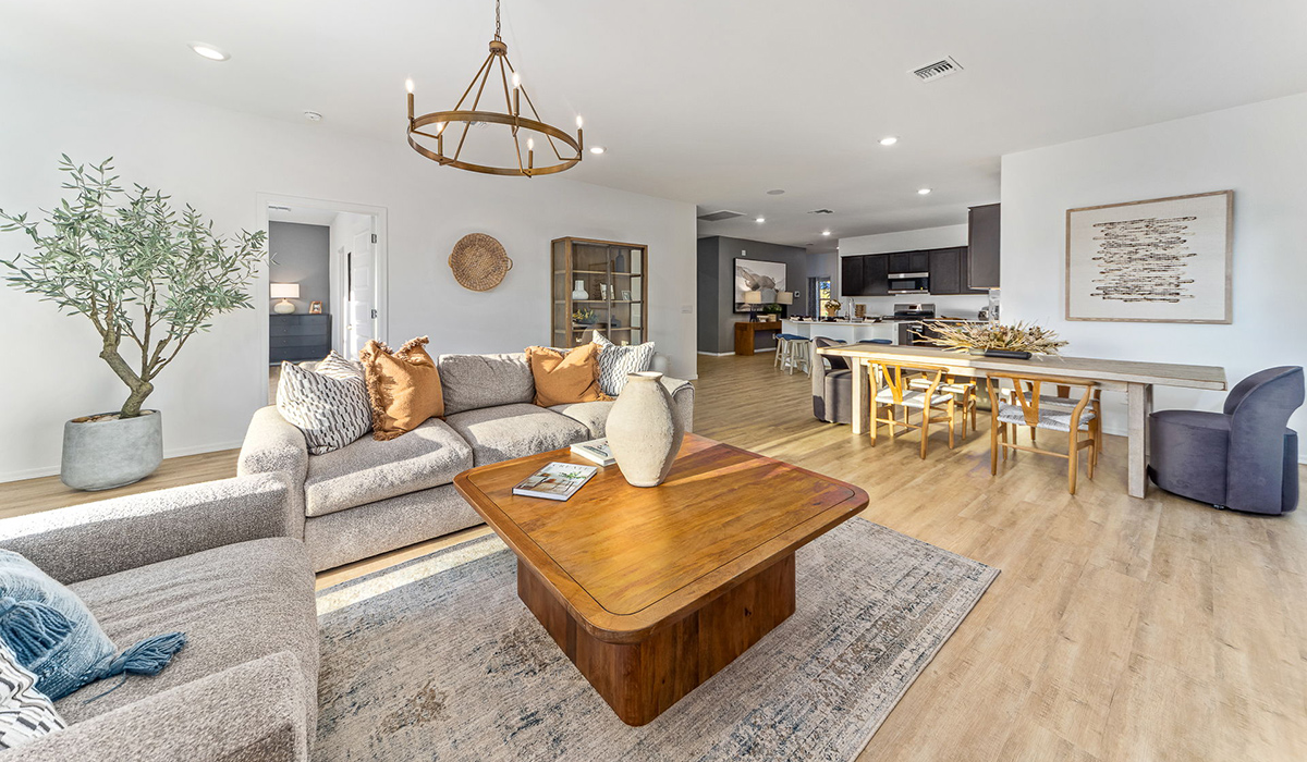 Step into The Kingston at Barnett Village, Marana, Arizona – a perfect blend of comfort, modern living, and energy efficiency. This thoughtfully crafted one-story home spans 2,068 square feet and offers four bedrooms and two bathrooms, ideal for families of all sizes.  The open-concept design features a spacious great room that effortlessly connects with the kitchen and dining area, creating an inviting central hub for everyday living and entertaining. The kitchen is equipped with contemporary appliances and a pantry, offering ample storage and convenience for meal preparation.  The primary bedroom, located at the rear of the home, provides a peaceful retreat with a private ensuite bathroom and a generous walk-in closet. The additional three bedrooms are positioned at the front of the house, offering versatility for use as guest rooms, a home office, or children’s bedrooms. Step outside to the covered patio, a perfect spot to enjoy the beautiful Arizona weather, whether for morning coffee or evening relaxation.  The Kingston also boasts a covered patio, perfect for enjoying Arizona’s beautiful desert evenings. Whether it’s morning coffee or evening relaxation, this outdoor space extends your living area into the serene landscape of Barnett Village.  Built with energy efficiency as a priority, the Kingston includes smart home technology, which not only simplifies daily living but also helps reduce utility costs. A two-car garage provides ample parking and additional storage space, enhancing the home’s functionality.  Images shown are for reference only. They depict the sales model home and may not represent the actual home.