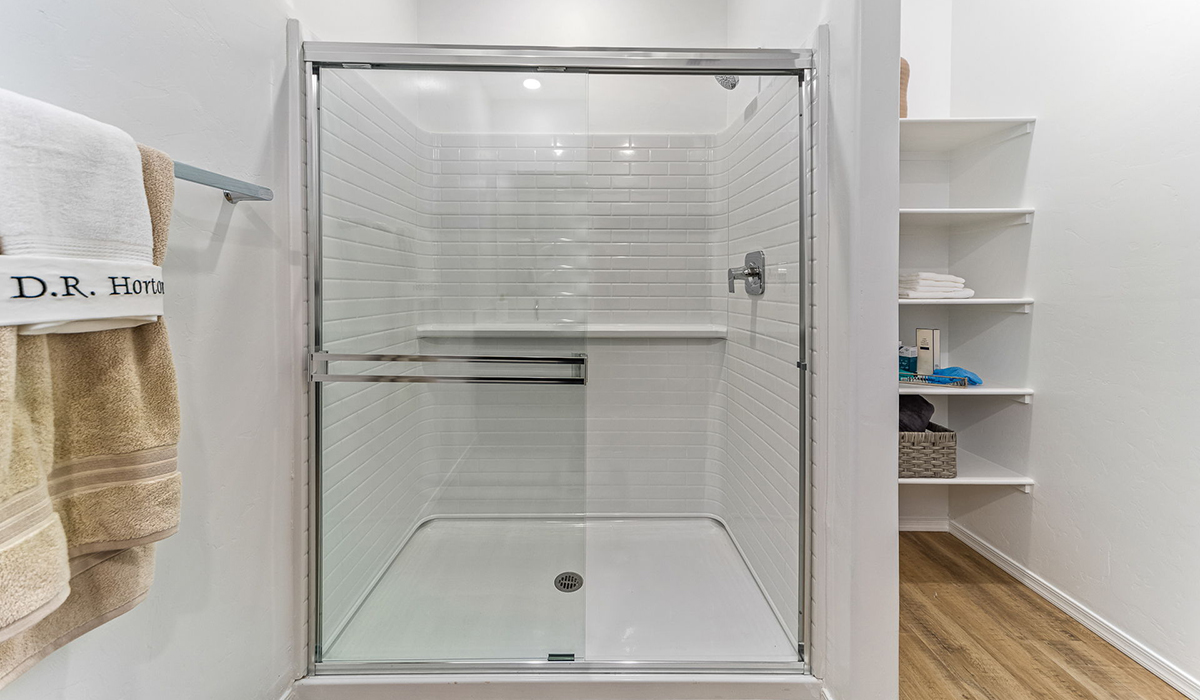 Step into The Kingston at Barnett Village, Marana, Arizona – a perfect blend of comfort, modern living, and energy efficiency. This thoughtfully crafted one-story home spans 2,068 square feet and offers four bedrooms and two bathrooms, ideal for families of all sizes.  The open-concept design features a spacious great room that effortlessly connects with the kitchen and dining area, creating an inviting central hub for everyday living and entertaining. The kitchen is equipped with contemporary appliances and a pantry, offering ample storage and convenience for meal preparation.  The primary bedroom, located at the rear of the home, provides a peaceful retreat with a private ensuite bathroom and a generous walk-in closet. The additional three bedrooms are positioned at the front of the house, offering versatility for use as guest rooms, a home office, or children’s bedrooms. Step outside to the covered patio, a perfect spot to enjoy the beautiful Arizona weather, whether for morning coffee or evening relaxation.  The Kingston also boasts a covered patio, perfect for enjoying Arizona’s beautiful desert evenings. Whether it’s morning coffee or evening relaxation, this outdoor space extends your living area into the serene landscape of Barnett Village.  Built with energy efficiency as a priority, the Kingston includes smart home technology, which not only simplifies daily living but also helps reduce utility costs. A two-car garage provides ample parking and additional storage space, enhancing the home’s functionality.  Images shown are for reference only. They depict the sales model home and may not represent the actual home.