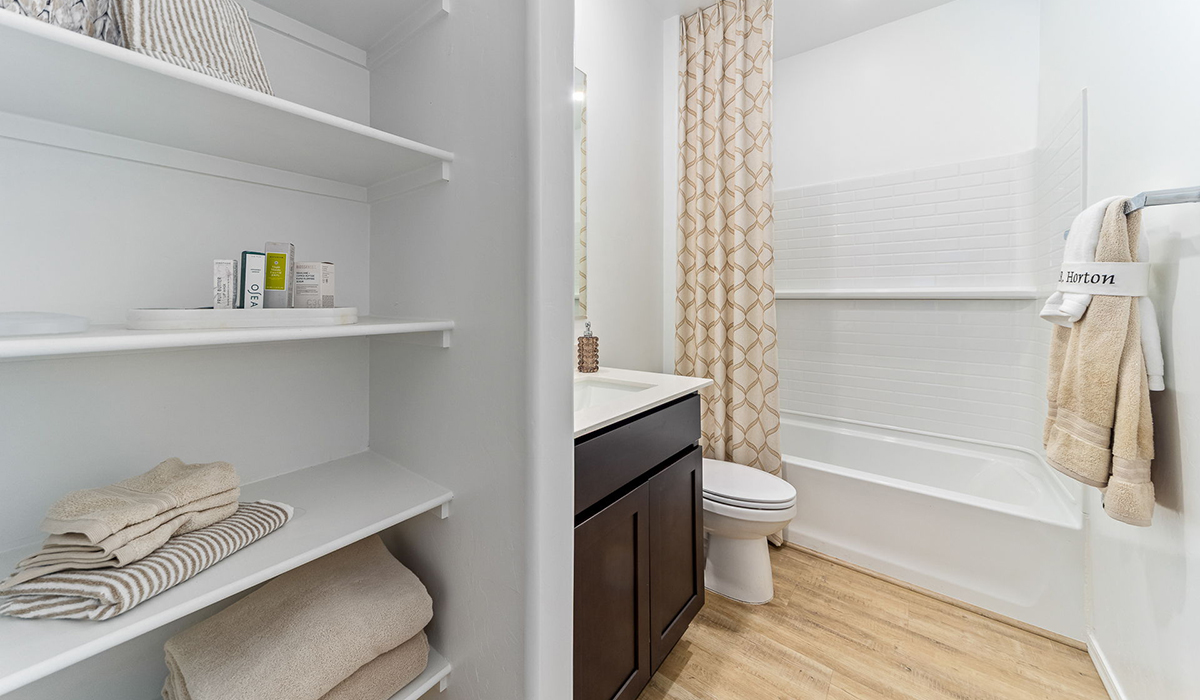 Step into The Kingston at Barnett Village, Marana, Arizona – a perfect blend of comfort, modern living, and energy efficiency. This thoughtfully crafted one-story home spans 2,068 square feet and offers four bedrooms and two bathrooms, ideal for families of all sizes.  The open-concept design features a spacious great room that effortlessly connects with the kitchen and dining area, creating an inviting central hub for everyday living and entertaining. The kitchen is equipped with contemporary appliances and a pantry, offering ample storage and convenience for meal preparation.  The primary bedroom, located at the rear of the home, provides a peaceful retreat with a private ensuite bathroom and a generous walk-in closet. The additional three bedrooms are positioned at the front of the house, offering versatility for use as guest rooms, a home office, or children’s bedrooms. Step outside to the covered patio, a perfect spot to enjoy the beautiful Arizona weather, whether for morning coffee or evening relaxation.  The Kingston also boasts a covered patio, perfect for enjoying Arizona’s beautiful desert evenings. Whether it’s morning coffee or evening relaxation, this outdoor space extends your living area into the serene landscape of Barnett Village.  Built with energy efficiency as a priority, the Kingston includes smart home technology, which not only simplifies daily living but also helps reduce utility costs. A two-car garage provides ample parking and additional storage space, enhancing the home’s functionality.  Images shown are for reference only. They depict the sales model home and may not represent the actual home.