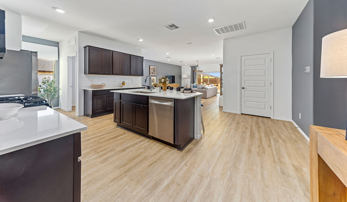 Step into The Kingston at Barnett Village, Marana, Arizona – a perfect blend of comfort, modern living, and energy efficiency. This thoughtfully crafted one-story home spans 2,068 square feet and offers four bedrooms and two bathrooms, ideal for families of all sizes.  The open-concept design features a spacious great room that effortlessly connects with the kitchen and dining area, creating an inviting central hub for everyday living and entertaining. The kitchen is equipped with contemporary appliances and a pantry, offering ample storage and convenience for meal preparation.  The primary bedroom, located at the rear of the home, provides a peaceful retreat with a private ensuite bathroom and a generous walk-in closet. The additional three bedrooms are positioned at the front of the house, offering versatility for use as guest rooms, a home office, or children’s bedrooms. Step outside to the covered patio, a perfect spot to enjoy the beautiful Arizona weather, whether for morning coffee or evening relaxation.  The Kingston also boasts a covered patio, perfect for enjoying Arizona’s beautiful desert evenings. Whether it’s morning coffee or evening relaxation, this outdoor space extends your living area into the serene landscape of Barnett Village.  Built with energy efficiency as a priority, the Kingston includes smart home technology, which not only simplifies daily living but also helps reduce utility costs. A two-car garage provides ample parking and additional storage space, enhancing the home’s functionality.  Images shown are for reference only. They depict the sales model home and may not represent the actual home.
