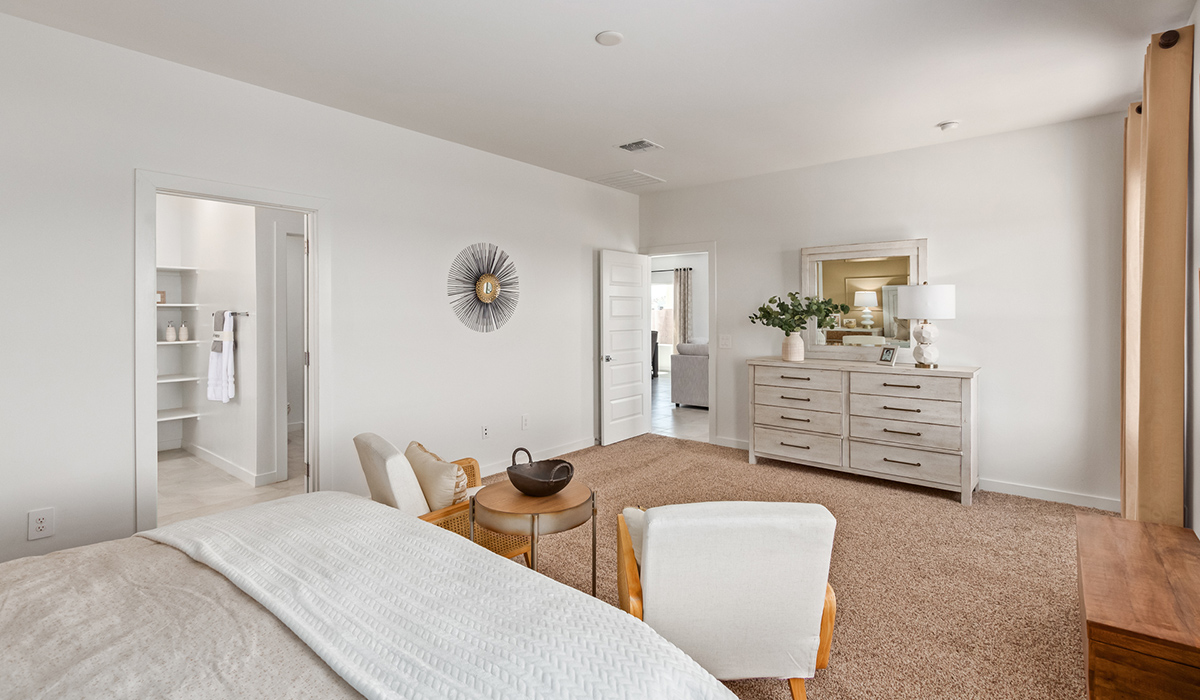 Step into The Kingston at Barnett Village, Marana, Arizona – a perfect blend of comfort, modern living, and energy efficiency. This thoughtfully crafted one-story home spans 2,068 square feet and offers four bedrooms and two bathrooms, ideal for families of all sizes.  The open-concept design features a spacious great room that effortlessly connects with the kitchen and dining area, creating an inviting central hub for everyday living and entertaining. The kitchen is equipped with contemporary appliances and a pantry, offering ample storage and convenience for meal preparation.  The primary bedroom, located at the rear of the home, provides a peaceful retreat with a private ensuite bathroom and a generous walk-in closet. The additional three bedrooms are positioned at the front of the house, offering versatility for use as guest rooms, a home office, or children’s bedrooms. Step outside to the covered patio, a perfect spot to enjoy the beautiful Arizona weather, whether for morning coffee or evening relaxation.  The Kingston also boasts a covered patio, perfect for enjoying Arizona’s beautiful desert evenings. Whether it’s morning coffee or evening relaxation, this outdoor space extends your living area into the serene landscape of Barnett Village.  Built with energy efficiency as a priority, the Kingston includes smart home technology, which not only simplifies daily living but also helps reduce utility costs. A two-car garage provides ample parking and additional storage space, enhancing the home’s functionality.