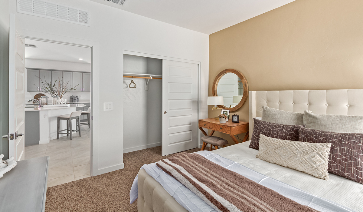 Step into The Kingston at Barnett Village, Marana, Arizona – a perfect blend of comfort, modern living, and energy efficiency. This thoughtfully crafted one-story home spans 2,068 square feet and offers four bedrooms and two bathrooms, ideal for families of all sizes.  The open-concept design features a spacious great room that effortlessly connects with the kitchen and dining area, creating an inviting central hub for everyday living and entertaining. The kitchen is equipped with contemporary appliances and a pantry, offering ample storage and convenience for meal preparation.  The primary bedroom, located at the rear of the home, provides a peaceful retreat with a private ensuite bathroom and a generous walk-in closet. The additional three bedrooms are positioned at the front of the house, offering versatility for use as guest rooms, a home office, or children’s bedrooms. Step outside to the covered patio, a perfect spot to enjoy the beautiful Arizona weather, whether for morning coffee or evening relaxation.  The Kingston also boasts a covered patio, perfect for enjoying Arizona’s beautiful desert evenings. Whether it’s morning coffee or evening relaxation, this outdoor space extends your living area into the serene landscape of Barnett Village.  Built with energy efficiency as a priority, the Kingston includes smart home technology, which not only simplifies daily living but also helps reduce utility costs. A two-car garage provides ample parking and additional storage space, enhancing the home’s functionality.