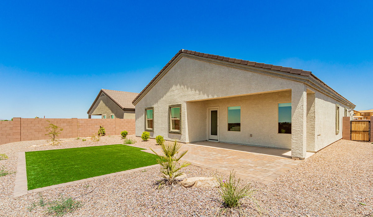 Step into The Kingston at Barnett Village, Marana, Arizona – a perfect blend of comfort, modern living, and energy efficiency. This thoughtfully crafted one-story home spans 2,068 square feet and offers four bedrooms and two bathrooms, ideal for families of all sizes.  The open-concept design features a spacious great room that effortlessly connects with the kitchen and dining area, creating an inviting central hub for everyday living and entertaining. The kitchen is equipped with contemporary appliances and a pantry, offering ample storage and convenience for meal preparation.  The primary bedroom, located at the rear of the home, provides a peaceful retreat with a private ensuite bathroom and a generous walk-in closet. The additional three bedrooms are positioned at the front of the house, offering versatility for use as guest rooms, a home office, or children’s bedrooms. Step outside to the covered patio, a perfect spot to enjoy the beautiful Arizona weather, whether for morning coffee or evening relaxation.  The Kingston also boasts a covered patio, perfect for enjoying Arizona’s beautiful desert evenings. Whether it’s morning coffee or evening relaxation, this outdoor space extends your living area into the serene landscape of Barnett Village.  Built with energy efficiency as a priority, the Kingston includes smart home technology, which not only simplifies daily living but also helps reduce utility costs. A two-car garage provides ample parking and additional storage space, enhancing the home’s functionality.
