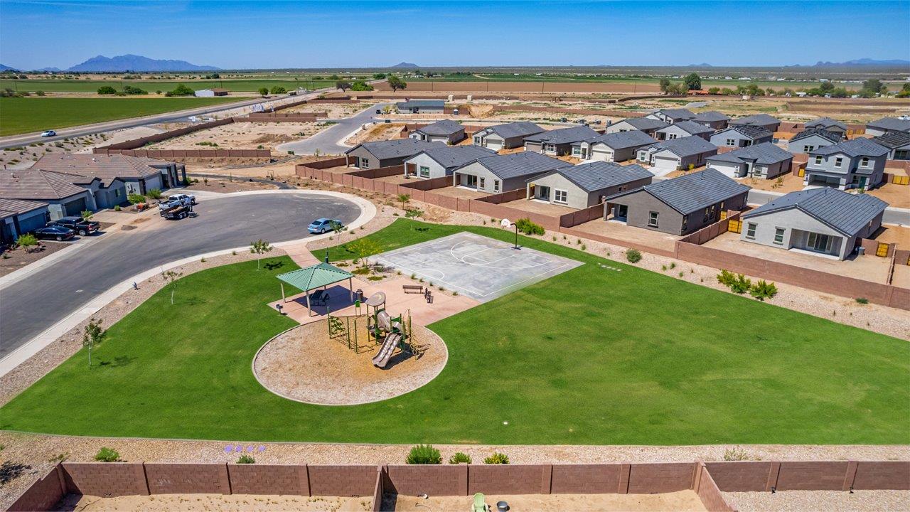 Welcome to The Parker at Barnett Village in Marana, Arizona – a stunning 1,909 sq. ft. single-story new home that combines space, comfort, and modern design for today’s growing families.  As you step through the inviting front porch and into the entryway, you’re immediately greeted by a well-thought-out floorplan that offers ample space for everyone. Just off the entry, Bedroom 5 is ideally situated for guests or as a private home office, complete with easy access to a full bathroom.  Moving further into the home, the spacious great room serves as the heart of The Parker. This open-concept area connects seamlessly to the dining room and kitchen, creating a perfect setting for both family gatherings and everyday living. The kitchen is a chef’s delight, featuring sleek granite countertops, modern appliances, a large island with a breakfast bar, and a walk-in pantry that ensures plenty of storage space.  Down a private hallway, you’ll discover the luxurious master suite. This spacious bedroom offers a serene retreat within the home, complete with a large walk-in closet and an en-suite bathroom featuring dual vanities and a walk-in shower. Three additional bedrooms are located nearby, sharing access to a full bathroom, making it easy to accommodate family and guests alike.  The Parker also includes a utility room conveniently located near the bedrooms, and a two-car garage that offers both storage and functionality.  Step outside from the great room to the covered patio – an ideal spot for enjoying Arizona’s beautiful weather year-round. Whether you’re hosting a barbecue or simply relaxing with a book, this outdoor space extends your living area into the serene surroundings of Barnett Village.  Designed with energy efficiency in mind, The Parker at Barnett Village is DOE Zero Energy Ready Home certified, ensuring a sustainable and cost-effective living environment.