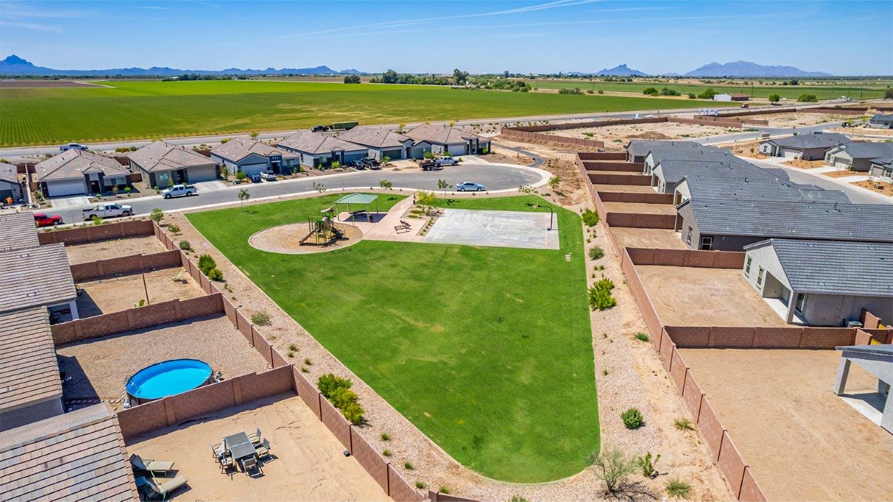 Welcome to The Parker at Barnett Village in Marana, Arizona – a stunning 1,909 sq. ft. single-story new home that combines space, comfort, and modern design for today’s growing families.  As you step through the inviting front porch and into the entryway, you’re immediately greeted by a well-thought-out floorplan that offers ample space for everyone. Just off the entry, Bedroom 5 is ideally situated for guests or as a private home office, complete with easy access to a full bathroom.  Moving further into the home, the spacious great room serves as the heart of The Parker. This open-concept area connects seamlessly to the dining room and kitchen, creating a perfect setting for both family gatherings and everyday living. The kitchen is a chef’s delight, featuring sleek granite countertops, modern appliances, a large island with a breakfast bar, and a walk-in pantry that ensures plenty of storage space.  Down a private hallway, you’ll discover the luxurious master suite. This spacious bedroom offers a serene retreat within the home, complete with a large walk-in closet and an en-suite bathroom featuring dual vanities and a walk-in shower. Three additional bedrooms are located nearby, sharing access to a full bathroom, making it easy to accommodate family and guests alike.  The Parker also includes a utility room conveniently located near the bedrooms, and a two-car garage that offers both storage and functionality.  Step outside from the great room to the covered patio – an ideal spot for enjoying Arizona’s beautiful weather year-round. Whether you’re hosting a barbecue or simply relaxing with a book, this outdoor space extends your living area into the serene surroundings of Barnett Village.  Designed with energy efficiency in mind, The Parker at Barnett Village is DOE Zero Energy Ready Home certified, ensuring a sustainable and cost-effective living environment.