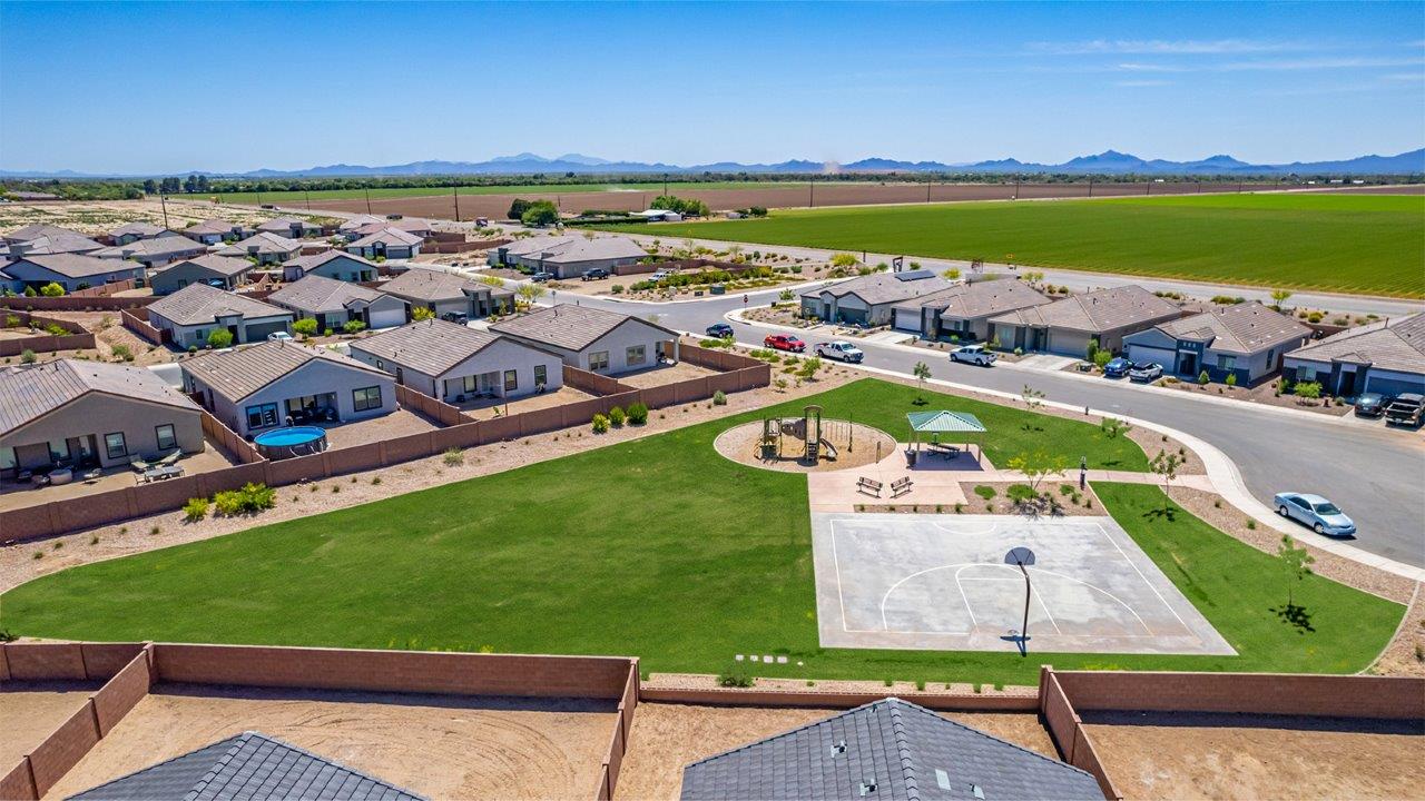 Welcome to The Parker at Barnett Village in Marana, Arizona – a stunning 1,909 sq. ft. single-story new home that combines space, comfort, and modern design for today’s growing families.  As you step through the inviting front porch and into the entryway, you’re immediately greeted by a well-thought-out floorplan that offers ample space for everyone. Just off the entry, Bedroom 5 is ideally situated for guests or as a private home office, complete with easy access to a full bathroom.  Moving further into the home, the spacious great room serves as the heart of The Parker. This open-concept area connects seamlessly to the dining room and kitchen, creating a perfect setting for both family gatherings and everyday living. The kitchen is a chef’s delight, featuring sleek granite countertops, modern appliances, a large island with a breakfast bar, and a walk-in pantry that ensures plenty of storage space.  Down a private hallway, you’ll discover the luxurious master suite. This spacious bedroom offers a serene retreat within the home, complete with a large walk-in closet and an en-suite bathroom featuring dual vanities and a walk-in shower. Three additional bedrooms are located nearby, sharing access to a full bathroom, making it easy to accommodate family and guests alike.  The Parker also includes a utility room conveniently located near the bedrooms, and a two-car garage that offers both storage and functionality.  Step outside from the great room to the covered patio – an ideal spot for enjoying Arizona’s beautiful weather year-round. Whether you’re hosting a barbecue or simply relaxing with a book, this outdoor space extends your living area into the serene surroundings of Barnett Village.  Designed with energy efficiency in mind, The Parker at Barnett Village is DOE Zero Energy Ready Home certified, ensuring a sustainable and cost-effective living environment.