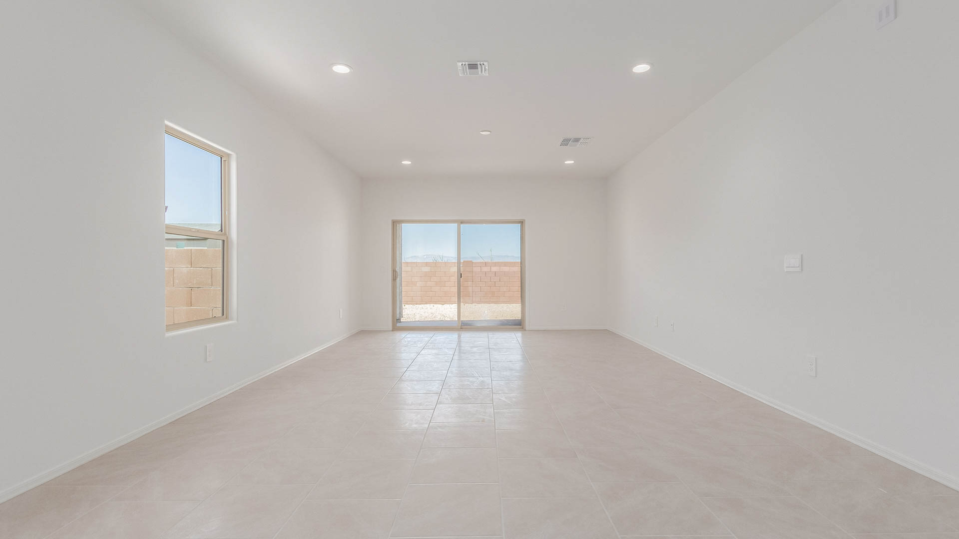 Welcome to The Parker at Barnett Village in Marana, Arizona – a stunning 1,909 sq. ft. single-story new home that combines space, comfort, and modern design for today’s growing families.  As you step through the inviting front porch and into the entryway, you’re immediately greeted by a well-thought-out floorplan that offers ample space for everyone. Just off the entry, Bedroom 5 is ideally situated for guests or as a private home office, complete with easy access to a full bathroom.  Moving further into the home, the spacious great room serves as the heart of The Parker. This open-concept area connects seamlessly to the dining room and kitchen, creating a perfect setting for both family gatherings and everyday living. The kitchen is a chef’s delight, featuring sleek granite countertops, modern appliances, a large island with a breakfast bar, and a walk-in pantry that ensures plenty of storage space.  Down a private hallway, you’ll discover the luxurious master suite. This spacious bedroom offers a serene retreat within the home, complete with a large walk-in closet and an en-suite bathroom featuring dual vanities and a walk-in shower. Three additional bedrooms are located nearby, sharing access to a full bathroom, making it easy to accommodate family and guests alike.  The Parker also includes a utility room conveniently located near the bedrooms, and a two-car garage that offers both storage and functionality.  Step outside from the great room to the covered patio – an ideal spot for enjoying Arizona’s beautiful weather year-round. Whether you’re hosting a barbecue or simply relaxing with a book, this outdoor space extends your living area into the serene surroundings of Barnett Village.  Designed with energy efficiency in mind, The Parker at Barnett Village is DOE Zero Energy Ready Home certified, ensuring a sustainable and cost-effective living environment.