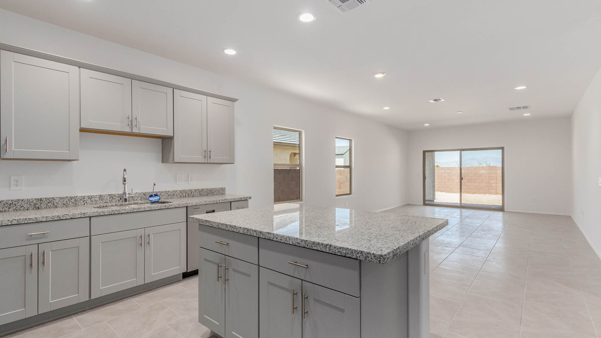 Welcome to The Parker at Barnett Village in Marana, Arizona – a stunning 1,909 sq. ft. single-story new home that combines space, comfort, and modern design for today’s growing families.  As you step through the inviting front porch and into the entryway, you’re immediately greeted by a well-thought-out floorplan that offers ample space for everyone. Just off the entry, Bedroom 5 is ideally situated for guests or as a private home office, complete with easy access to a full bathroom.  Moving further into the home, the spacious great room serves as the heart of The Parker. This open-concept area connects seamlessly to the dining room and kitchen, creating a perfect setting for both family gatherings and everyday living. The kitchen is a chef’s delight, featuring sleek granite countertops, modern appliances, a large island with a breakfast bar, and a walk-in pantry that ensures plenty of storage space.  Down a private hallway, you’ll discover the luxurious master suite. This spacious bedroom offers a serene retreat within the home, complete with a large walk-in closet and an en-suite bathroom featuring dual vanities and a walk-in shower. Three additional bedrooms are located nearby, sharing access to a full bathroom, making it easy to accommodate family and guests alike.  The Parker also includes a utility room conveniently located near the bedrooms, and a two-car garage that offers both storage and functionality.  Step outside from the great room to the covered patio – an ideal spot for enjoying Arizona’s beautiful weather year-round. Whether you’re hosting a barbecue or simply relaxing with a book, this outdoor space extends your living area into the serene surroundings of Barnett Village.  Designed with energy efficiency in mind, The Parker at Barnett Village is DOE Zero Energy Ready Home certified, ensuring a sustainable and cost-effective living environment.