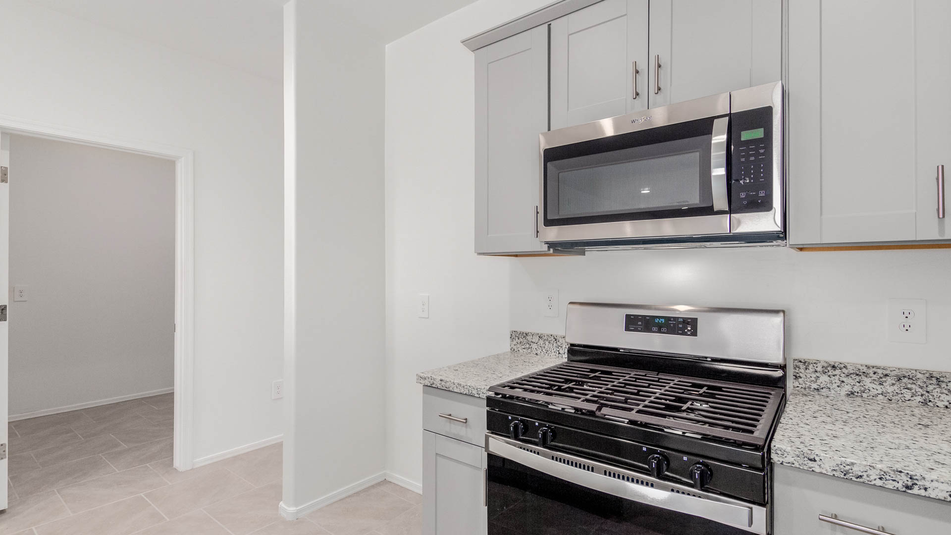 Welcome to The Parker at Barnett Village in Marana, Arizona – a stunning 1,909 sq. ft. single-story new home that combines space, comfort, and modern design for today’s growing families.  As you step through the inviting front porch and into the entryway, you’re immediately greeted by a well-thought-out floorplan that offers ample space for everyone. Just off the entry, Bedroom 5 is ideally situated for guests or as a private home office, complete with easy access to a full bathroom.  Moving further into the home, the spacious great room serves as the heart of The Parker. This open-concept area connects seamlessly to the dining room and kitchen, creating a perfect setting for both family gatherings and everyday living. The kitchen is a chef’s delight, featuring sleek granite countertops, modern appliances, a large island with a breakfast bar, and a walk-in pantry that ensures plenty of storage space.  Down a private hallway, you’ll discover the luxurious master suite. This spacious bedroom offers a serene retreat within the home, complete with a large walk-in closet and an en-suite bathroom featuring dual vanities and a walk-in shower. Three additional bedrooms are located nearby, sharing access to a full bathroom, making it easy to accommodate family and guests alike.  The Parker also includes a utility room conveniently located near the bedrooms, and a two-car garage that offers both storage and functionality.  Step outside from the great room to the covered patio – an ideal spot for enjoying Arizona’s beautiful weather year-round. Whether you’re hosting a barbecue or simply relaxing with a book, this outdoor space extends your living area into the serene surroundings of Barnett Village.  Designed with energy efficiency in mind, The Parker at Barnett Village is DOE Zero Energy Ready Home certified, ensuring a sustainable and cost-effective living environment.