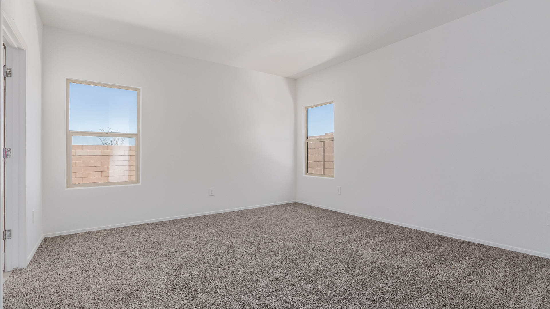 Welcome to The Parker at Barnett Village in Marana, Arizona – a stunning 1,909 sq. ft. single-story new home that combines space, comfort, and modern design for today’s growing families.  As you step through the inviting front porch and into the entryway, you’re immediately greeted by a well-thought-out floorplan that offers ample space for everyone. Just off the entry, Bedroom 5 is ideally situated for guests or as a private home office, complete with easy access to a full bathroom.  Moving further into the home, the spacious great room serves as the heart of The Parker. This open-concept area connects seamlessly to the dining room and kitchen, creating a perfect setting for both family gatherings and everyday living. The kitchen is a chef’s delight, featuring sleek granite countertops, modern appliances, a large island with a breakfast bar, and a walk-in pantry that ensures plenty of storage space.  Down a private hallway, you’ll discover the luxurious master suite. This spacious bedroom offers a serene retreat within the home, complete with a large walk-in closet and an en-suite bathroom featuring dual vanities and a walk-in shower. Three additional bedrooms are located nearby, sharing access to a full bathroom, making it easy to accommodate family and guests alike.  The Parker also includes a utility room conveniently located near the bedrooms, and a two-car garage that offers both storage and functionality.  Step outside from the great room to the covered patio – an ideal spot for enjoying Arizona’s beautiful weather year-round. Whether you’re hosting a barbecue or simply relaxing with a book, this outdoor space extends your living area into the serene surroundings of Barnett Village.  Designed with energy efficiency in mind, The Parker at Barnett Village is DOE Zero Energy Ready Home certified, ensuring a sustainable and cost-effective living environment.