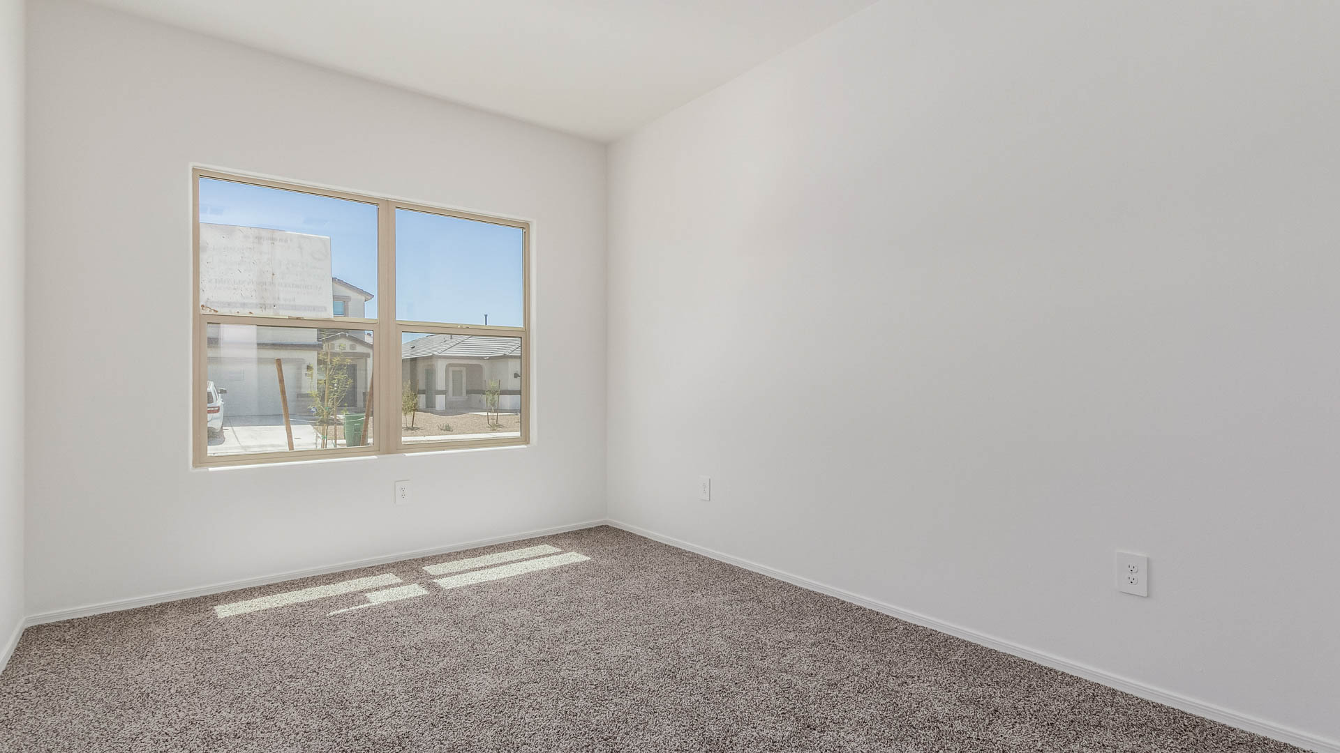 Welcome to The Parker at Barnett Village in Marana, Arizona – a stunning 1,909 sq. ft. single-story new home that combines space, comfort, and modern design for today’s growing families.  As you step through the inviting front porch and into the entryway, you’re immediately greeted by a well-thought-out floorplan that offers ample space for everyone. Just off the entry, Bedroom 5 is ideally situated for guests or as a private home office, complete with easy access to a full bathroom.  Moving further into the home, the spacious great room serves as the heart of The Parker. This open-concept area connects seamlessly to the dining room and kitchen, creating a perfect setting for both family gatherings and everyday living. The kitchen is a chef’s delight, featuring sleek granite countertops, modern appliances, a large island with a breakfast bar, and a walk-in pantry that ensures plenty of storage space.  Down a private hallway, you’ll discover the luxurious master suite. This spacious bedroom offers a serene retreat within the home, complete with a large walk-in closet and an en-suite bathroom featuring dual vanities and a walk-in shower. Three additional bedrooms are located nearby, sharing access to a full bathroom, making it easy to accommodate family and guests alike.  The Parker also includes a utility room conveniently located near the bedrooms, and a two-car garage that offers both storage and functionality.  Step outside from the great room to the covered patio – an ideal spot for enjoying Arizona’s beautiful weather year-round. Whether you’re hosting a barbecue or simply relaxing with a book, this outdoor space extends your living area into the serene surroundings of Barnett Village.  Designed with energy efficiency in mind, The Parker at Barnett Village is DOE Zero Energy Ready Home certified, ensuring a sustainable and cost-effective living environment.