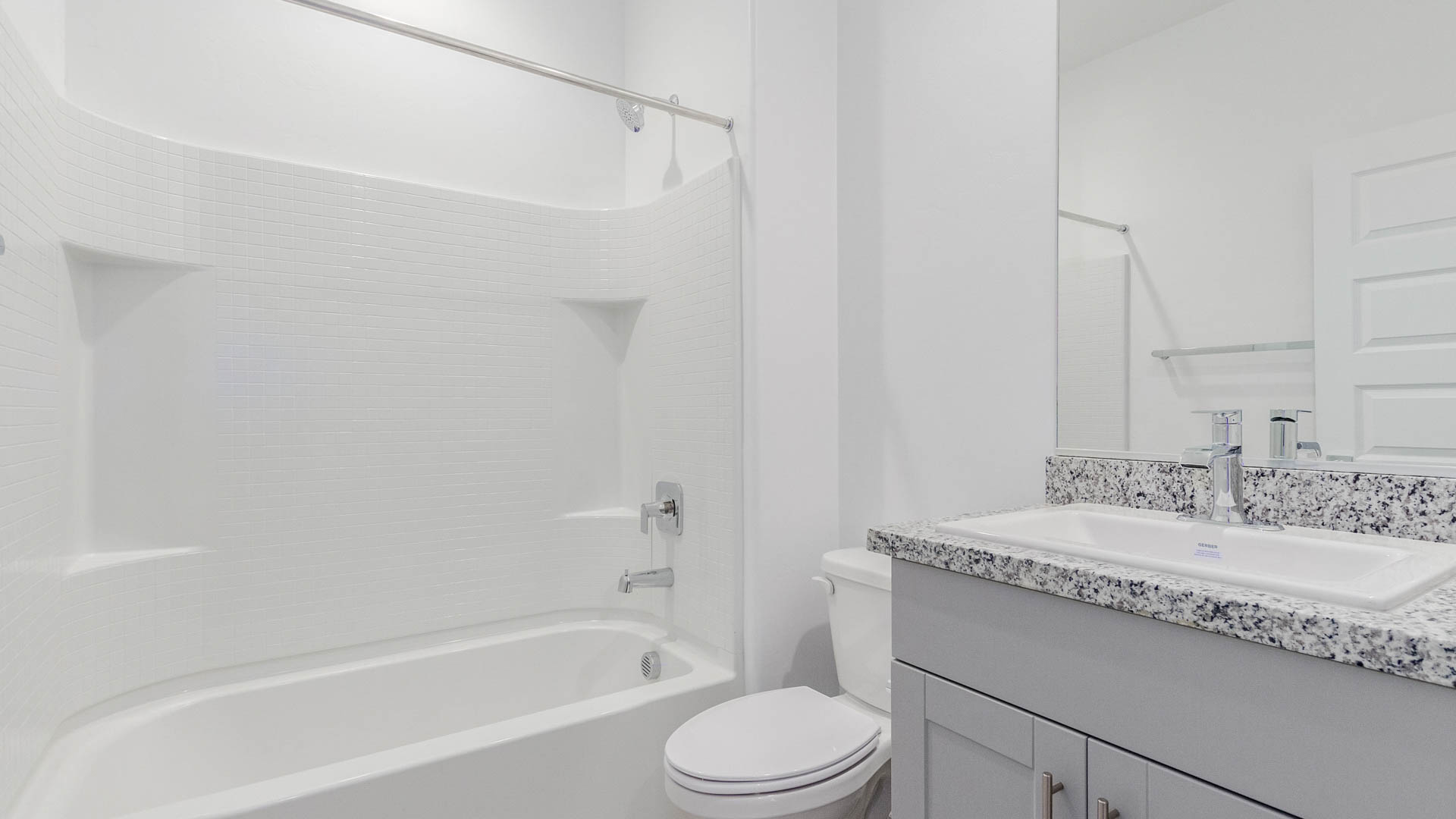 Welcome to The Parker at Barnett Village in Marana, Arizona – a stunning 1,909 sq. ft. single-story new home that combines space, comfort, and modern design for today’s growing families.  As you step through the inviting front porch and into the entryway, you’re immediately greeted by a well-thought-out floorplan that offers ample space for everyone. Just off the entry, Bedroom 5 is ideally situated for guests or as a private home office, complete with easy access to a full bathroom.  Moving further into the home, the spacious great room serves as the heart of The Parker. This open-concept area connects seamlessly to the dining room and kitchen, creating a perfect setting for both family gatherings and everyday living. The kitchen is a chef’s delight, featuring sleek granite countertops, modern appliances, a large island with a breakfast bar, and a walk-in pantry that ensures plenty of storage space.  Down a private hallway, you’ll discover the luxurious master suite. This spacious bedroom offers a serene retreat within the home, complete with a large walk-in closet and an en-suite bathroom featuring dual vanities and a walk-in shower. Three additional bedrooms are located nearby, sharing access to a full bathroom, making it easy to accommodate family and guests alike.  The Parker also includes a utility room conveniently located near the bedrooms, and a two-car garage that offers both storage and functionality.  Step outside from the great room to the covered patio – an ideal spot for enjoying Arizona’s beautiful weather year-round. Whether you’re hosting a barbecue or simply relaxing with a book, this outdoor space extends your living area into the serene surroundings of Barnett Village.  Designed with energy efficiency in mind, The Parker at Barnett Village is DOE Zero Energy Ready Home certified, ensuring a sustainable and cost-effective living environment.