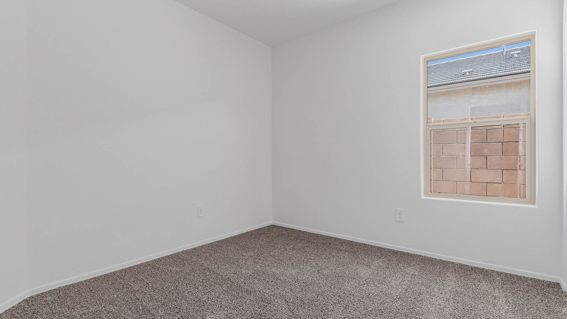 Welcome to The Parker at Barnett Village in Marana, Arizona – a stunning 1,909 sq. ft. single-story new home that combines space, comfort, and modern design for today’s growing families.  As you step through the inviting front porch and into the entryway, you’re immediately greeted by a well-thought-out floorplan that offers ample space for everyone. Just off the entry, Bedroom 5 is ideally situated for guests or as a private home office, complete with easy access to a full bathroom.  Moving further into the home, the spacious great room serves as the heart of The Parker. This open-concept area connects seamlessly to the dining room and kitchen, creating a perfect setting for both family gatherings and everyday living. The kitchen is a chef’s delight, featuring sleek granite countertops, modern appliances, a large island with a breakfast bar, and a walk-in pantry that ensures plenty of storage space.  Down a private hallway, you’ll discover the luxurious master suite. This spacious bedroom offers a serene retreat within the home, complete with a large walk-in closet and an en-suite bathroom featuring dual vanities and a walk-in shower. Three additional bedrooms are located nearby, sharing access to a full bathroom, making it easy to accommodate family and guests alike.  The Parker also includes a utility room conveniently located near the bedrooms, and a two-car garage that offers both storage and functionality.  Step outside from the great room to the covered patio – an ideal spot for enjoying Arizona’s beautiful weather year-round. Whether you’re hosting a barbecue or simply relaxing with a book, this outdoor space extends your living area into the serene surroundings of Barnett Village.  Designed with energy efficiency in mind, The Parker at Barnett Village is DOE Zero Energy Ready Home certified, ensuring a sustainable and cost-effective living environment.