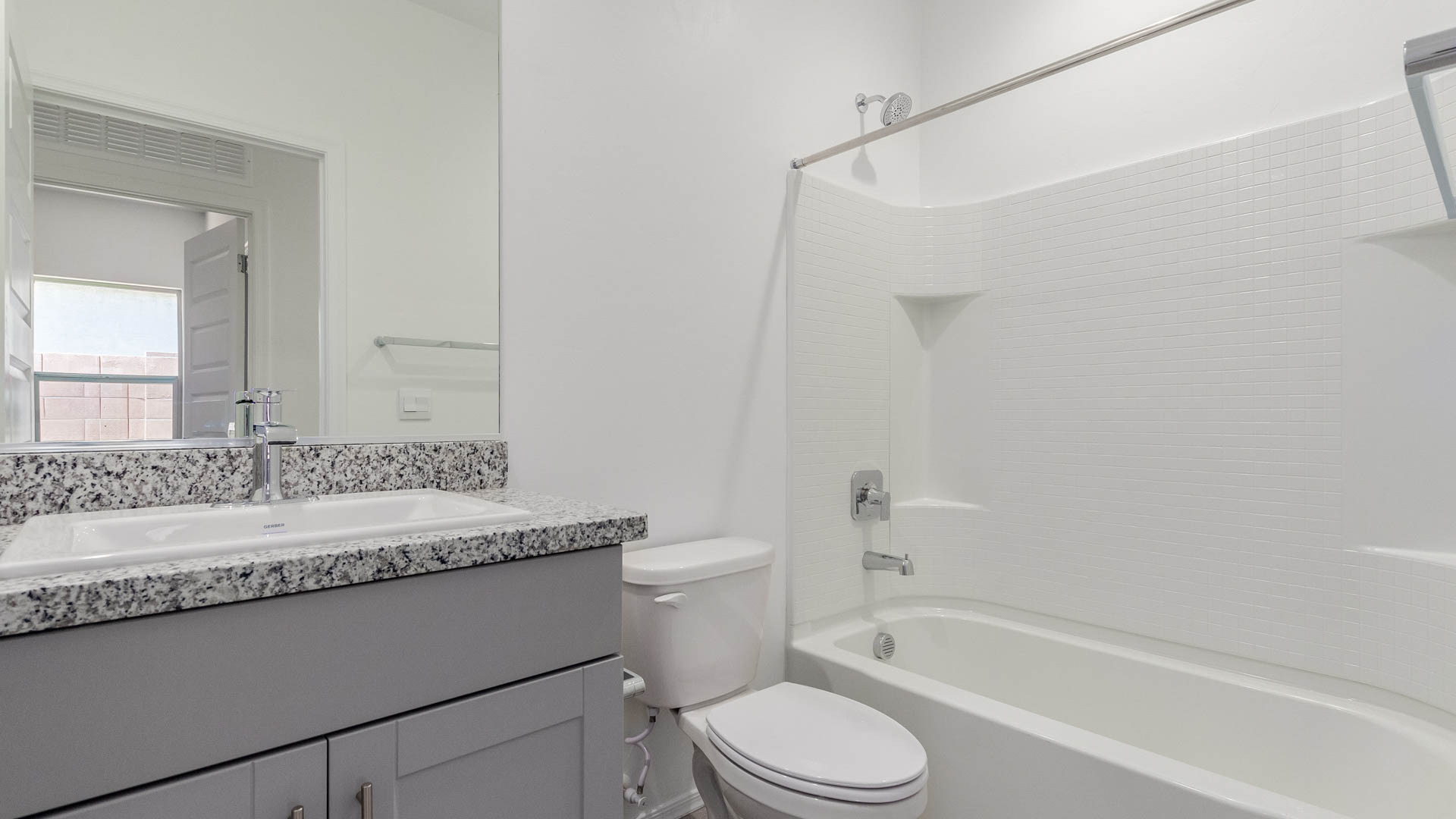 Welcome to The Parker at Barnett Village in Marana, Arizona – a stunning 1,909 sq. ft. single-story new home that combines space, comfort, and modern design for today’s growing families.  As you step through the inviting front porch and into the entryway, you’re immediately greeted by a well-thought-out floorplan that offers ample space for everyone. Just off the entry, Bedroom 5 is ideally situated for guests or as a private home office, complete with easy access to a full bathroom.  Moving further into the home, the spacious great room serves as the heart of The Parker. This open-concept area connects seamlessly to the dining room and kitchen, creating a perfect setting for both family gatherings and everyday living. The kitchen is a chef’s delight, featuring sleek granite countertops, modern appliances, a large island with a breakfast bar, and a walk-in pantry that ensures plenty of storage space.  Down a private hallway, you’ll discover the luxurious master suite. This spacious bedroom offers a serene retreat within the home, complete with a large walk-in closet and an en-suite bathroom featuring dual vanities and a walk-in shower. Three additional bedrooms are located nearby, sharing access to a full bathroom, making it easy to accommodate family and guests alike.  The Parker also includes a utility room conveniently located near the bedrooms, and a two-car garage that offers both storage and functionality.  Step outside from the great room to the covered patio – an ideal spot for enjoying Arizona’s beautiful weather year-round. Whether you’re hosting a barbecue or simply relaxing with a book, this outdoor space extends your living area into the serene surroundings of Barnett Village.  Designed with energy efficiency in mind, The Parker at Barnett Village is DOE Zero Energy Ready Home certified, ensuring a sustainable and cost-effective living environment.