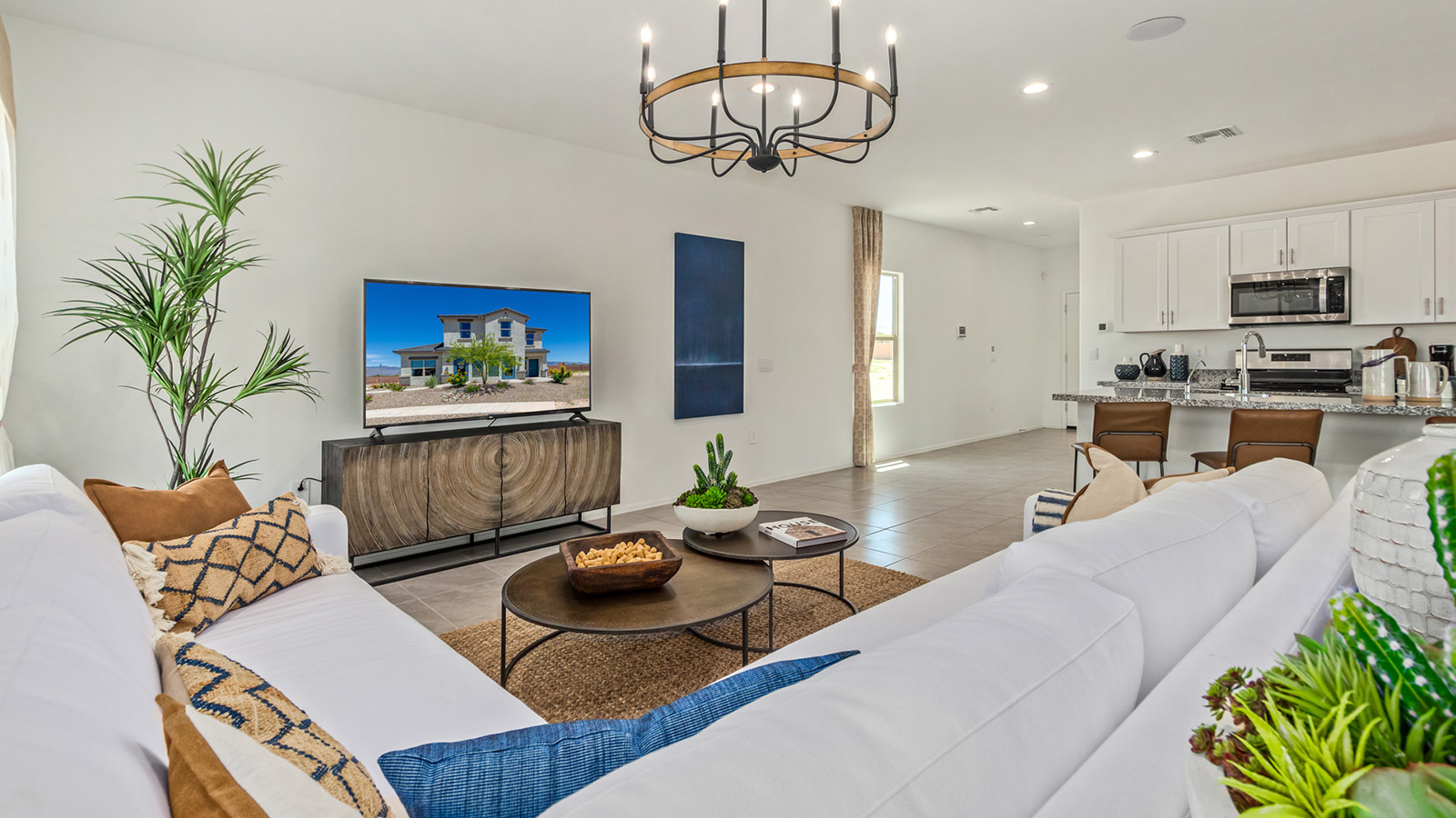 Introducing The Kate at Barnett Village in Marana, Arizona – the only two-story home in the community, offering an impressive 2,264 sq. ft. of living space designed to accommodate families of all sizes with ease and style.  As you enter through the charming front porch, you're greeted by an inviting entryway that leads directly into the heart of the home. The spacious great room opens up ahead, seamlessly connecting to the dining area and the gourmet kitchen. This open-concept space is perfect for entertaining, allowing for a natural flow from meal preparation to dining to relaxation. The kitchen features sleek granite countertops, a large island with a breakfast bar, modern appliances, and a walk-in pantry, making it both functional and stylish.  Tucked away on the main floor is a powder room, adding convenience for guests and everyday living.   Heading upstairs, you'll discover the family’s private quarters. The master suite is a true retreat, offering a generously sized bedroom, a large walk-in closet, and an en-suite bathroom complete with dual vanities and a walk-in shower. The upper level also includes three additional bedrooms, a full bathroom, and a versatile game room that can easily serve as a playroom, media room, or even a second living area.  For added convenience, the laundry room is located on the upper level, making household chores a breeze. The Kate also includes a two-car garage and energy-efficient features, ensuring long-term savings and a comfortable living environment.  Step outside from the great room to the covered patio, where you can enjoy Arizona’s stunning desert landscapes. Whether you’re hosting an outdoor gathering or simply relaxing after a long day, this space extends your living area and enhances the home’s inviting ambiance.  Designed with energy efficiency in mind, The Kate at Barnett Village is DOE Zero Energy Ready Home certified, combining sustainability with modern comfort.