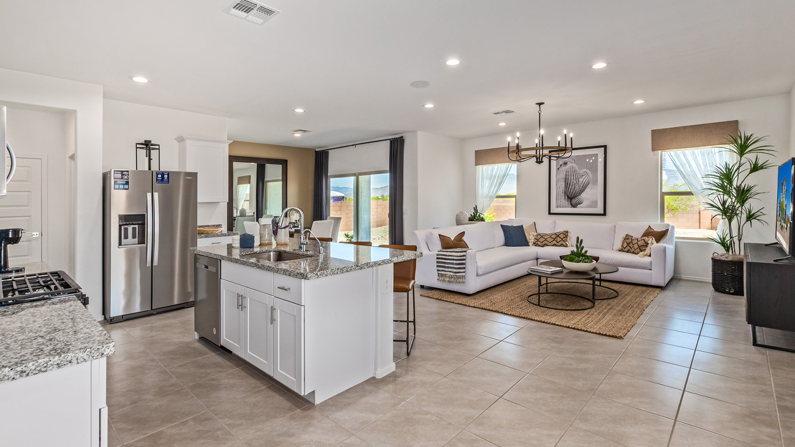 Introducing The Kate at Barnett Village in Marana, Arizona – the only two-story home in the community, offering an impressive 2,264 sq. ft. of living space designed to accommodate families of all sizes with ease and style.  As you enter through the charming front porch, you're greeted by an inviting entryway that leads directly into the heart of the home. The spacious great room opens up ahead, seamlessly connecting to the dining area and the gourmet kitchen. This open-concept space is perfect for entertaining, allowing for a natural flow from meal preparation to dining to relaxation. The kitchen features sleek granite countertops, a large island with a breakfast bar, modern appliances, and a walk-in pantry, making it both functional and stylish.  Tucked away on the main floor is a powder room, adding convenience for guests and everyday living.   Heading upstairs, you'll discover the family’s private quarters. The master suite is a true retreat, offering a generously sized bedroom, a large walk-in closet, and an en-suite bathroom complete with dual vanities and a walk-in shower. The upper level also includes three additional bedrooms, a full bathroom, and a versatile game room that can easily serve as a playroom, media room, or even a second living area.  For added convenience, the laundry room is located on the upper level, making household chores a breeze. The Kate also includes a two-car garage and energy-efficient features, ensuring long-term savings and a comfortable living environment.  Step outside from the great room to the covered patio, where you can enjoy Arizona’s stunning desert landscapes. Whether you’re hosting an outdoor gathering or simply relaxing after a long day, this space extends your living area and enhances the home’s inviting ambiance.  Designed with energy efficiency in mind, The Kate at Barnett Village is DOE Zero Energy Ready Home certified, combining sustainability with modern comfort.