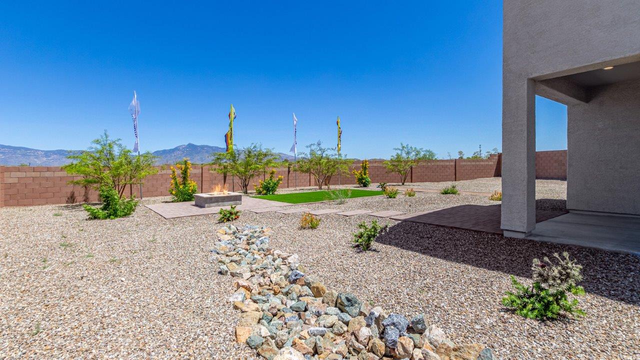 Introducing The Kate at Barnett Village in Marana, Arizona – the only two-story home in the community, offering an impressive 2,264 sq. ft. of living space designed to accommodate families of all sizes with ease and style.  As you enter through the charming front porch, you're greeted by an inviting entryway that leads directly into the heart of the home. The spacious great room opens up ahead, seamlessly connecting to the dining area and the gourmet kitchen. This open-concept space is perfect for entertaining, allowing for a natural flow from meal preparation to dining to relaxation. The kitchen features sleek granite countertops, a large island with a breakfast bar, modern appliances, and a walk-in pantry, making it both functional and stylish.  Tucked away on the main floor is a powder room, adding convenience for guests and everyday living.   Heading upstairs, you'll discover the family’s private quarters. The master suite is a true retreat, offering a generously sized bedroom, a large walk-in closet, and an en-suite bathroom complete with dual vanities and a walk-in shower. The upper level also includes three additional bedrooms, a full bathroom, and a versatile game room that can easily serve as a playroom, media room, or even a second living area.  For added convenience, the laundry room is located on the upper level, making household chores a breeze. The Kate also includes a two-car garage and energy-efficient features, ensuring long-term savings and a comfortable living environment.  Step outside from the great room to the covered patio, where you can enjoy Arizona’s stunning desert landscapes. Whether you’re hosting an outdoor gathering or simply relaxing after a long day, this space extends your living area and enhances the home’s inviting ambiance.  Designed with energy efficiency in mind, The Kate at Barnett Village is DOE Zero Energy Ready Home certified, combining sustainability with modern comfort.