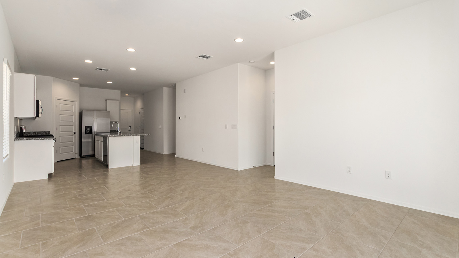 Explore The Dalton at Barnett Village in Marana, Arizona – a spacious 1,569 sq. ft. single-story new home designed to accommodate both comfort and convenience for modern living.  As you step through the front porch and into the welcoming entryway, you're immediately led into a thoughtfully designed space that maximizes every square foot. To the left, you’ll find Bedroom 4, ideal for guests or a home office, offering privacy and easy access to the main living areas.  Continuing through the home, you’ll enter the heart of The Dalton – an expansive great room that seamlessly connects to the dining area and kitchen. This open-concept space is perfect for entertaining or everyday family living, allowing for a fluid transition from cooking to dining to relaxation. The kitchen is equipped with sleek granite countertops, modern appliances, a walk-in pantry, and an island that doubles as a breakfast bar, providing ample space for meal prep and casual dining.  Adjacent to the great room, a hallway leads to three additional bedrooms, including the spacious master suite. The master bedroom offers a serene retreat with a large walk-in closet and an en-suite bathroom featuring dual vanities and a walk-in shower. The two secondary bedrooms share a well-appointed full bathroom, making it convenient for family members or guests.  The Dalton also includes a utility room that adds functionality and storage options to the home, as well as direct access to a two-car garage.  Step outside from the great room to the covered patio – a perfect spot to enjoy Arizona’s beautiful weather year-round, whether you’re sipping your morning coffee or hosting an evening barbecue.  Designed with energy efficiency in mind, The Dalton at Barnett Village is DOE Zero Energy Ready Home certified, ensuring long-term savings and a comfortable living environment.