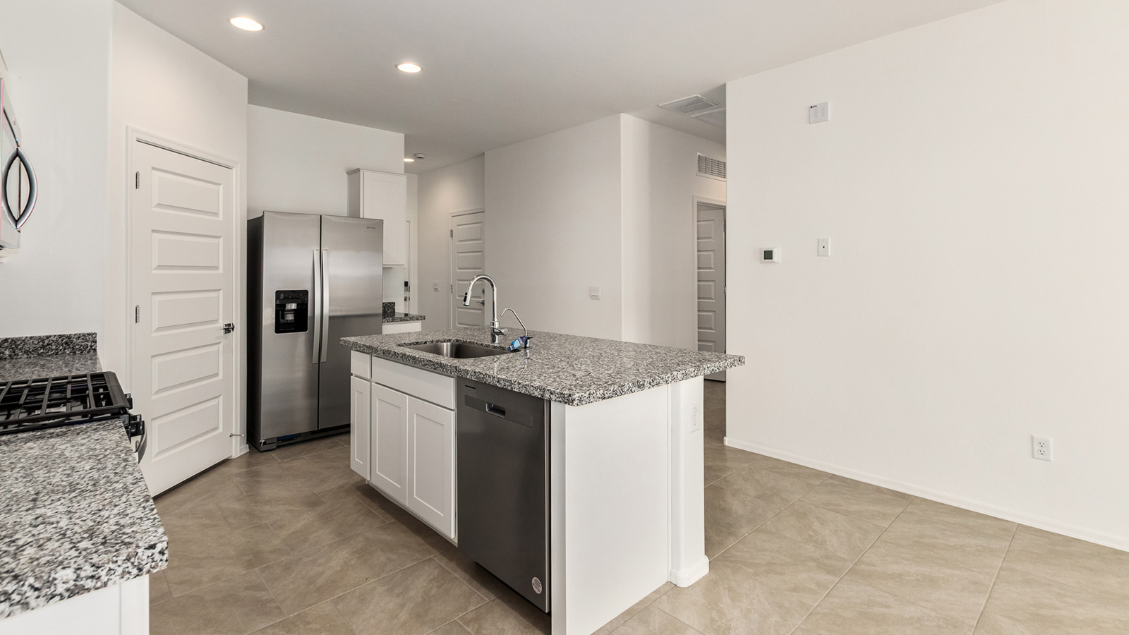 Explore The Dalton at Barnett Village in Marana, Arizona – a spacious 1,569 sq. ft. single-story new home designed to accommodate both comfort and convenience for modern living.  As you step through the front porch and into the welcoming entryway, you're immediately led into a thoughtfully designed space that maximizes every square foot. To the left, you’ll find Bedroom 4, ideal for guests or a home office, offering privacy and easy access to the main living areas.  Continuing through the home, you’ll enter the heart of The Dalton – an expansive great room that seamlessly connects to the dining area and kitchen. This open-concept space is perfect for entertaining or everyday family living, allowing for a fluid transition from cooking to dining to relaxation. The kitchen is equipped with sleek granite countertops, modern appliances, a walk-in pantry, and an island that doubles as a breakfast bar, providing ample space for meal prep and casual dining.  Adjacent to the great room, a hallway leads to three additional bedrooms, including the spacious master suite. The master bedroom offers a serene retreat with a large walk-in closet and an en-suite bathroom featuring dual vanities and a walk-in shower. The two secondary bedrooms share a well-appointed full bathroom, making it convenient for family members or guests.  The Dalton also includes a utility room that adds functionality and storage options to the home, as well as direct access to a two-car garage.  Step outside from the great room to the covered patio – a perfect spot to enjoy Arizona’s beautiful weather year-round, whether you’re sipping your morning coffee or hosting an evening barbecue.  Designed with energy efficiency in mind, The Dalton at Barnett Village is DOE Zero Energy Ready Home certified, ensuring long-term savings and a comfortable living environment.