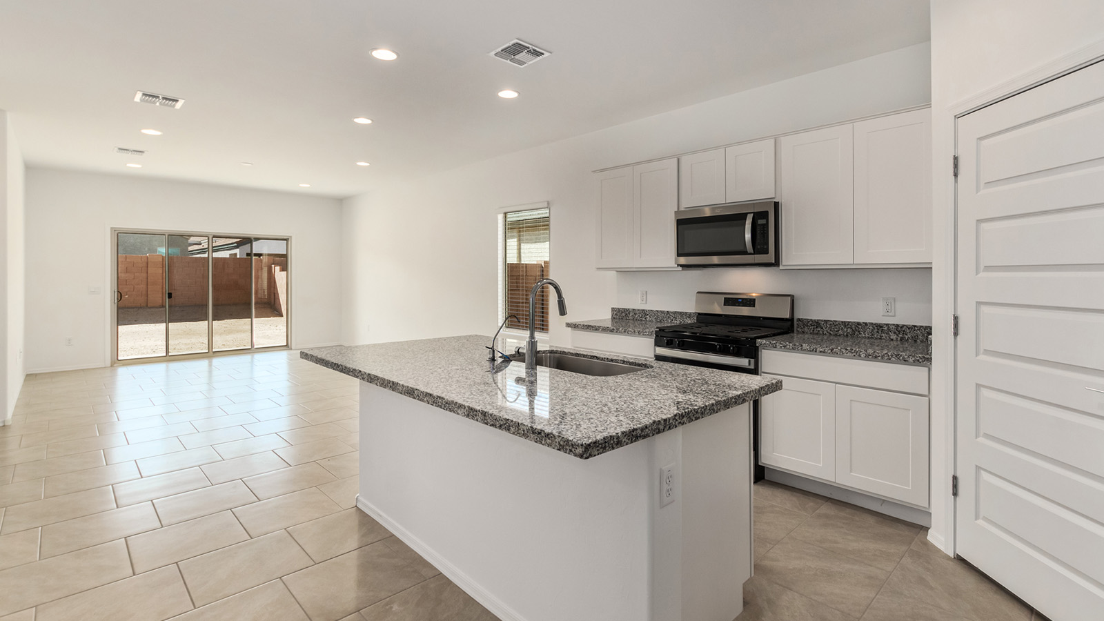 Explore The Dalton at Barnett Village in Marana, Arizona – a spacious 1,569 sq. ft. single-story new home designed to accommodate both comfort and convenience for modern living.  As you step through the front porch and into the welcoming entryway, you're immediately led into a thoughtfully designed space that maximizes every square foot. To the left, you’ll find Bedroom 4, ideal for guests or a home office, offering privacy and easy access to the main living areas.  Continuing through the home, you’ll enter the heart of The Dalton – an expansive great room that seamlessly connects to the dining area and kitchen. This open-concept space is perfect for entertaining or everyday family living, allowing for a fluid transition from cooking to dining to relaxation. The kitchen is equipped with sleek granite countertops, modern appliances, a walk-in pantry, and an island that doubles as a breakfast bar, providing ample space for meal prep and casual dining.  Adjacent to the great room, a hallway leads to three additional bedrooms, including the spacious master suite. The master bedroom offers a serene retreat with a large walk-in closet and an en-suite bathroom featuring dual vanities and a walk-in shower. The two secondary bedrooms share a well-appointed full bathroom, making it convenient for family members or guests.  The Dalton also includes a utility room that adds functionality and storage options to the home, as well as direct access to a two-car garage.  Step outside from the great room to the covered patio – a perfect spot to enjoy Arizona’s beautiful weather year-round, whether you’re sipping your morning coffee or hosting an evening barbecue.  Designed with energy efficiency in mind, The Dalton at Barnett Village is DOE Zero Energy Ready Home certified, ensuring long-term savings and a comfortable living environment.