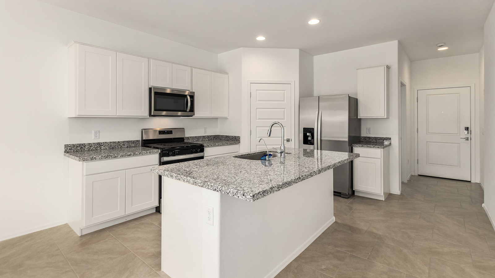 Explore The Dalton at Barnett Village in Marana, Arizona – a spacious 1,569 sq. ft. single-story new home designed to accommodate both comfort and convenience for modern living.  As you step through the front porch and into the welcoming entryway, you're immediately led into a thoughtfully designed space that maximizes every square foot. To the left, you’ll find Bedroom 4, ideal for guests or a home office, offering privacy and easy access to the main living areas.  Continuing through the home, you’ll enter the heart of The Dalton – an expansive great room that seamlessly connects to the dining area and kitchen. This open-concept space is perfect for entertaining or everyday family living, allowing for a fluid transition from cooking to dining to relaxation. The kitchen is equipped with sleek granite countertops, modern appliances, a walk-in pantry, and an island that doubles as a breakfast bar, providing ample space for meal prep and casual dining.  Adjacent to the great room, a hallway leads to three additional bedrooms, including the spacious master suite. The master bedroom offers a serene retreat with a large walk-in closet and an en-suite bathroom featuring dual vanities and a walk-in shower. The two secondary bedrooms share a well-appointed full bathroom, making it convenient for family members or guests.  The Dalton also includes a utility room that adds functionality and storage options to the home, as well as direct access to a two-car garage.  Step outside from the great room to the covered patio – a perfect spot to enjoy Arizona’s beautiful weather year-round, whether you’re sipping your morning coffee or hosting an evening barbecue.  Designed with energy efficiency in mind, The Dalton at Barnett Village is DOE Zero Energy Ready Home certified, ensuring long-term savings and a comfortable living environment.