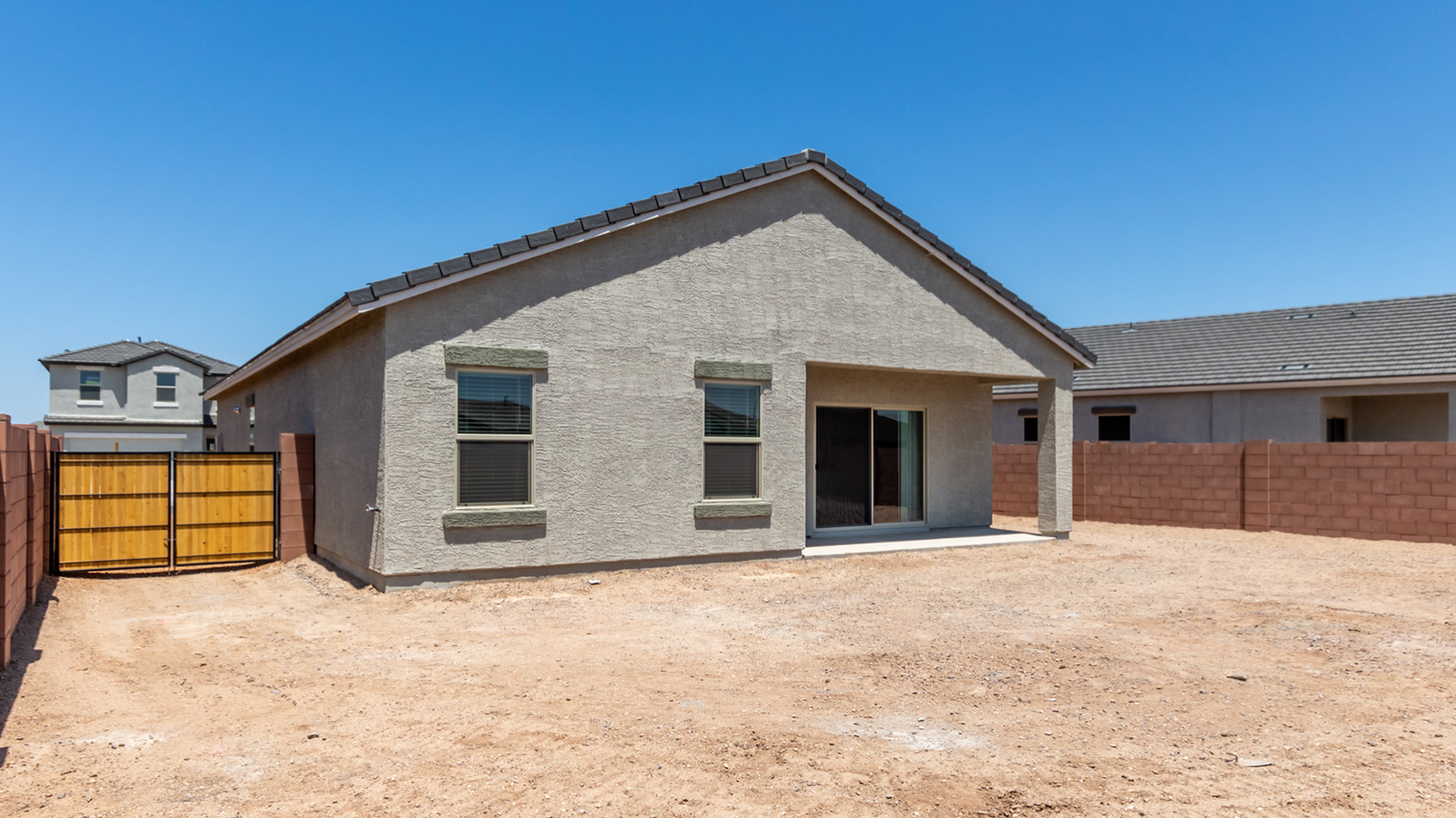 Discover The Easton at Barnett Village in Marana, Arizona – a spacious 1,701 sq. ft. single-story new home designed to offer both style and functionality for today’s modern family.  As you enter through the charming front porch, you’re welcomed into a thoughtful layout that makes every square foot count. Situated near the entrance you'll find the first bedroom, offering flexibility as a guest room, home office, or a cozy retreat.  Continuing down the hall, you’re led into the expansive great room, which flows seamlessly into the dining area and kitchen. This open-concept design ensures that the heart of the home is always connected, whether you’re preparing meals, dining, or relaxing with loved ones. The kitchen features sleek quartz countertops, a spacious center island, modern appliances, and a walk-in pantry that offers ample storage for all your cooking essentials.  The great room opens up to a covered patio, an ideal space to unwind and enjoy Arizona’s beautiful desert sunsets. Whether you’re hosting a weekend barbecue or enjoying a quiet evening outdoors, this patio extends your living space into the scenic surroundings of Barnett Village.  Just off the great room, a private hallway leads to the primary bedroom, which is a true retreat within the home. The primary suite is generously sized and includes a large walk-in closet and an en-suite bathroom, offering both luxury and convenience.   The Easton also features two additional bedrooms, well-positioned to share a full bathroom. These rooms are ideal for family members, providing comfortable living spaces with plenty of natural light.  For added convenience, the home includes a utility room and direct access to a two-car garage, making daily routines smoother and more efficient.  Designed with energy efficiency in mind, The Easton at Barnett Village is DOE Zero Energy Ready Home certified, ensuring both sustainability and savings.