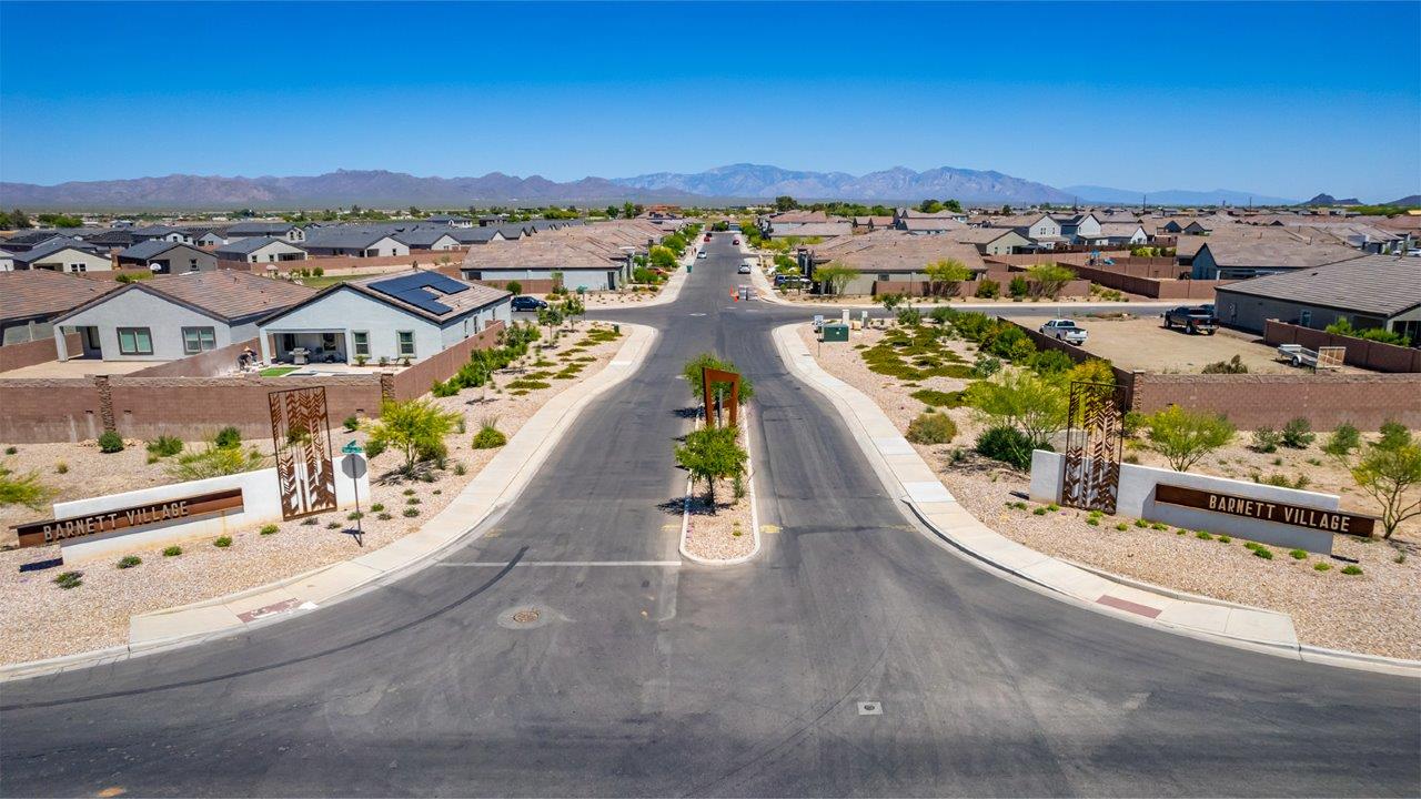 Discover The Easton at Barnett Village in Marana, Arizona – a spacious 1,701 sq. ft. single-story new home designed to offer both style and functionality for today’s modern family.  As you enter through the charming front porch, you’re welcomed into a thoughtful layout that makes every square foot count. Situated near the entrance you'll find the first bedroom, offering flexibility as a guest room, home office, or a cozy retreat.  Continuing down the hall, you’re led into the expansive great room, which flows seamlessly into the dining area and kitchen. This open-concept design ensures that the heart of the home is always connected, whether you’re preparing meals, dining, or relaxing with loved ones. The kitchen features sleek quartz countertops, a spacious center island, modern appliances, and a walk-in pantry that offers ample storage for all your cooking essentials.  The great room opens up to a covered patio, an ideal space to unwind and enjoy Arizona’s beautiful desert sunsets. Whether you’re hosting a weekend barbecue or enjoying a quiet evening outdoors, this patio extends your living space into the scenic surroundings of Barnett Village.  Just off the great room, a private hallway leads to the primary bedroom, which is a true retreat within the home. The primary suite is generously sized and includes a large walk-in closet and an en-suite bathroom, offering both luxury and convenience.   The Easton also features two additional bedrooms, well-positioned to share a full bathroom. These rooms are ideal for family members, providing comfortable living spaces with plenty of natural light.  For added convenience, the home includes a utility room and direct access to a two-car garage, making daily routines smoother and more efficient.  Designed with energy efficiency in mind, The Easton at Barnett Village is DOE Zero Energy Ready Home certified, ensuring both sustainability and savings.