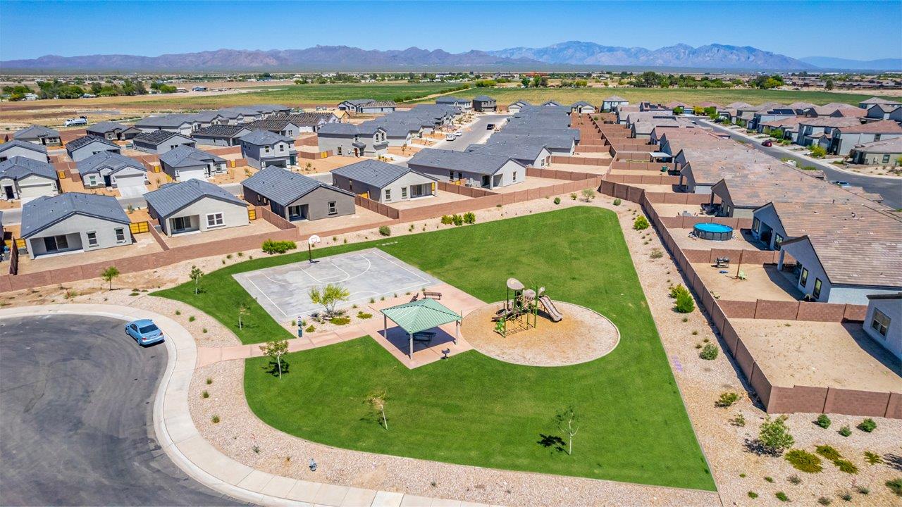 Discover The Easton at Barnett Village in Marana, Arizona – a spacious 1,701 sq. ft. single-story new home designed to offer both style and functionality for today’s modern family.  As you enter through the charming front porch, you’re welcomed into a thoughtful layout that makes every square foot count. Situated near the entrance you'll find the first bedroom, offering flexibility as a guest room, home office, or a cozy retreat.  Continuing down the hall, you’re led into the expansive great room, which flows seamlessly into the dining area and kitchen. This open-concept design ensures that the heart of the home is always connected, whether you’re preparing meals, dining, or relaxing with loved ones. The kitchen features sleek quartz countertops, a spacious center island, modern appliances, and a walk-in pantry that offers ample storage for all your cooking essentials.  The great room opens up to a covered patio, an ideal space to unwind and enjoy Arizona’s beautiful desert sunsets. Whether you’re hosting a weekend barbecue or enjoying a quiet evening outdoors, this patio extends your living space into the scenic surroundings of Barnett Village.  Just off the great room, a private hallway leads to the primary bedroom, which is a true retreat within the home. The primary suite is generously sized and includes a large walk-in closet and an en-suite bathroom, offering both luxury and convenience.   The Easton also features two additional bedrooms, well-positioned to share a full bathroom. These rooms are ideal for family members, providing comfortable living spaces with plenty of natural light.  For added convenience, the home includes a utility room and direct access to a two-car garage, making daily routines smoother and more efficient.  Designed with energy efficiency in mind, The Easton at Barnett Village is DOE Zero Energy Ready Home certified, ensuring both sustainability and savings.