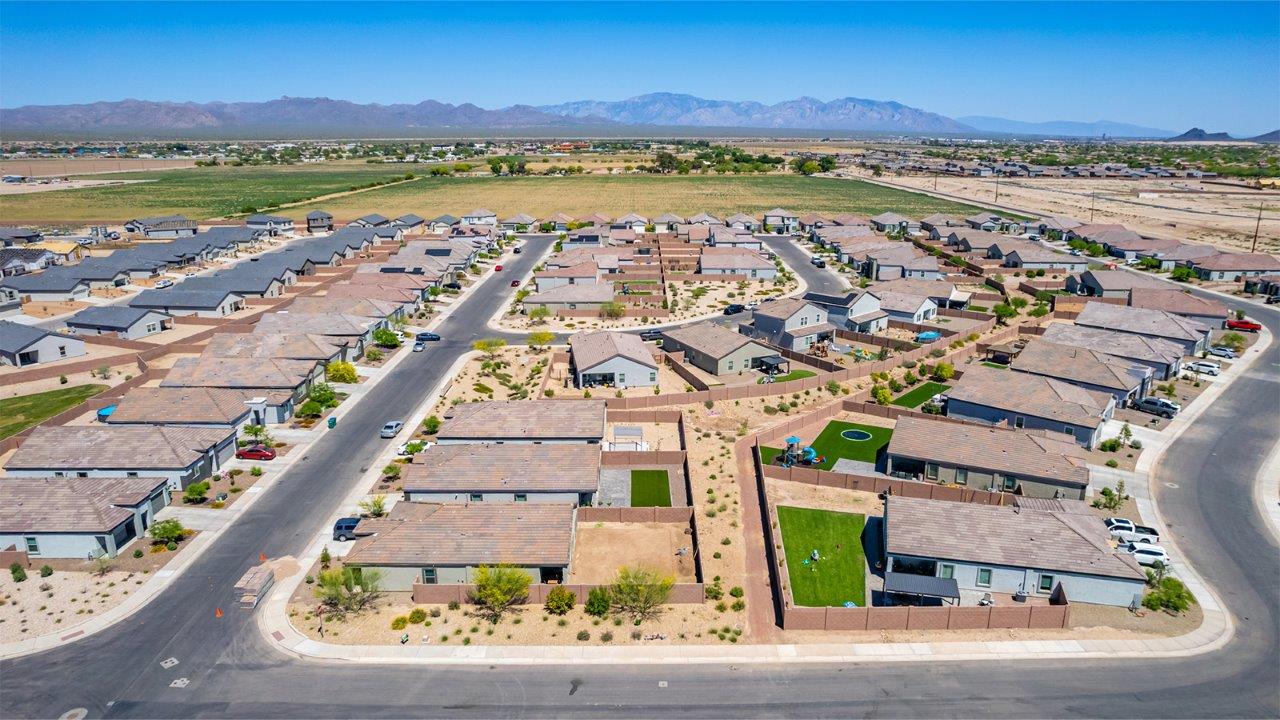 Discover The Easton at Barnett Village in Marana, Arizona – a spacious 1,701 sq. ft. single-story new home designed to offer both style and functionality for today’s modern family.  As you enter through the charming front porch, you’re welcomed into a thoughtful layout that makes every square foot count. Situated near the entrance you'll find the first bedroom, offering flexibility as a guest room, home office, or a cozy retreat.  Continuing down the hall, you’re led into the expansive great room, which flows seamlessly into the dining area and kitchen. This open-concept design ensures that the heart of the home is always connected, whether you’re preparing meals, dining, or relaxing with loved ones. The kitchen features sleek quartz countertops, a spacious center island, modern appliances, and a walk-in pantry that offers ample storage for all your cooking essentials.  The great room opens up to a covered patio, an ideal space to unwind and enjoy Arizona’s beautiful desert sunsets. Whether you’re hosting a weekend barbecue or enjoying a quiet evening outdoors, this patio extends your living space into the scenic surroundings of Barnett Village.  Just off the great room, a private hallway leads to the primary bedroom, which is a true retreat within the home. The primary suite is generously sized and includes a large walk-in closet and an en-suite bathroom, offering both luxury and convenience.   The Easton also features two additional bedrooms, well-positioned to share a full bathroom. These rooms are ideal for family members, providing comfortable living spaces with plenty of natural light.  For added convenience, the home includes a utility room and direct access to a two-car garage, making daily routines smoother and more efficient.  Designed with energy efficiency in mind, The Easton at Barnett Village is DOE Zero Energy Ready Home certified, ensuring both sustainability and savings.