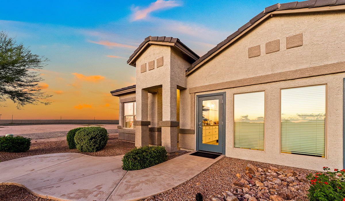 Welcome to The Harris at Barnett Village in Marana, Arizona – our beautifully designed home, offering 1,856 sq. ft. of modern living space that combines elegance with functionality.  Step through the inviting front porch and into a thoughtfully planned interior that begins with a welcoming entryway. This home features two of the four bedrooms near the entrance of the home, both sharing easy access to a full bathroom. These rooms are perfect for guests, children, or even a home office, providing comfort for various lifestyle needs.  As you continue through the spacious great room is revealed, the central hub of the home that seamlessly connects to the dining area and kitchen. The kitchen is a chef’s delight, complete with quartz countertops, large island with a breakfast bar, walk-in pantry, and state-of-the-art appliances.  Adjacent to the great room, a private hallway leads to the primary suite – a tranquil retreat within the home. The primary bedroom features a large walk-in closet and en-suite bathroom. Additionally, the suite offers direct access to a powder room, enhancing the convenience and privacy of this luxurious space.  The Harris also includes a utility room and a two-car garage adding to the home’s practical features, ensuring that daily routines are smooth and efficient.  Step outside to the covered patio, where you can unwind and take in the scenic beauty of Barnett Village. Whether you’re enjoying a quiet morning coffee or hosting a lively evening gathering, this outdoor space extends your living area and provides the perfect backdrop for Arizona’s desert landscapes.  *Images shown are for reference only. They depict The Harris sales model home and may not represent the actual home.