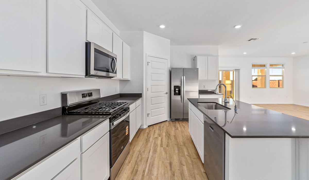 Step into The Dalea at Barnett Village, Marana, Arizona – a perfect blend of comfort, modern living, and energy efficiency. This thoughtfully crafted one-story home spans 2,224 square feet and offers five bedrooms and 3 bathrooms, ideal for families of all sizes.  The open-concept design features a spacious great room that effortlessly connects with the kitchen and dining area, creating an inviting central hub for everyday living and entertaining. The kitchen is equipped with contemporary appliances and a pantry, offering ample storage and convenience for meal preparation.  The primary bedroom, located at the rear of the home, provides a peaceful retreat with a private ensuite bathroom and a generous walk-in closet. The additional four bedrooms are positioned at the front of the house, offering versatility for use as guest rooms, a home office, or children’s bedrooms.  The Dalea floor plan offers the option of a three-car tandem garage, perfect for additional space and larger sized vehicles. Whether it’s morning coffee or evening relaxation, this outdoor space extends your living area into the serene landscape of Barnett Village.  Built with energy efficiency as a priority, the Dalea includes smart home technology, which not only simplifies daily living but also helps reduce utility costs.